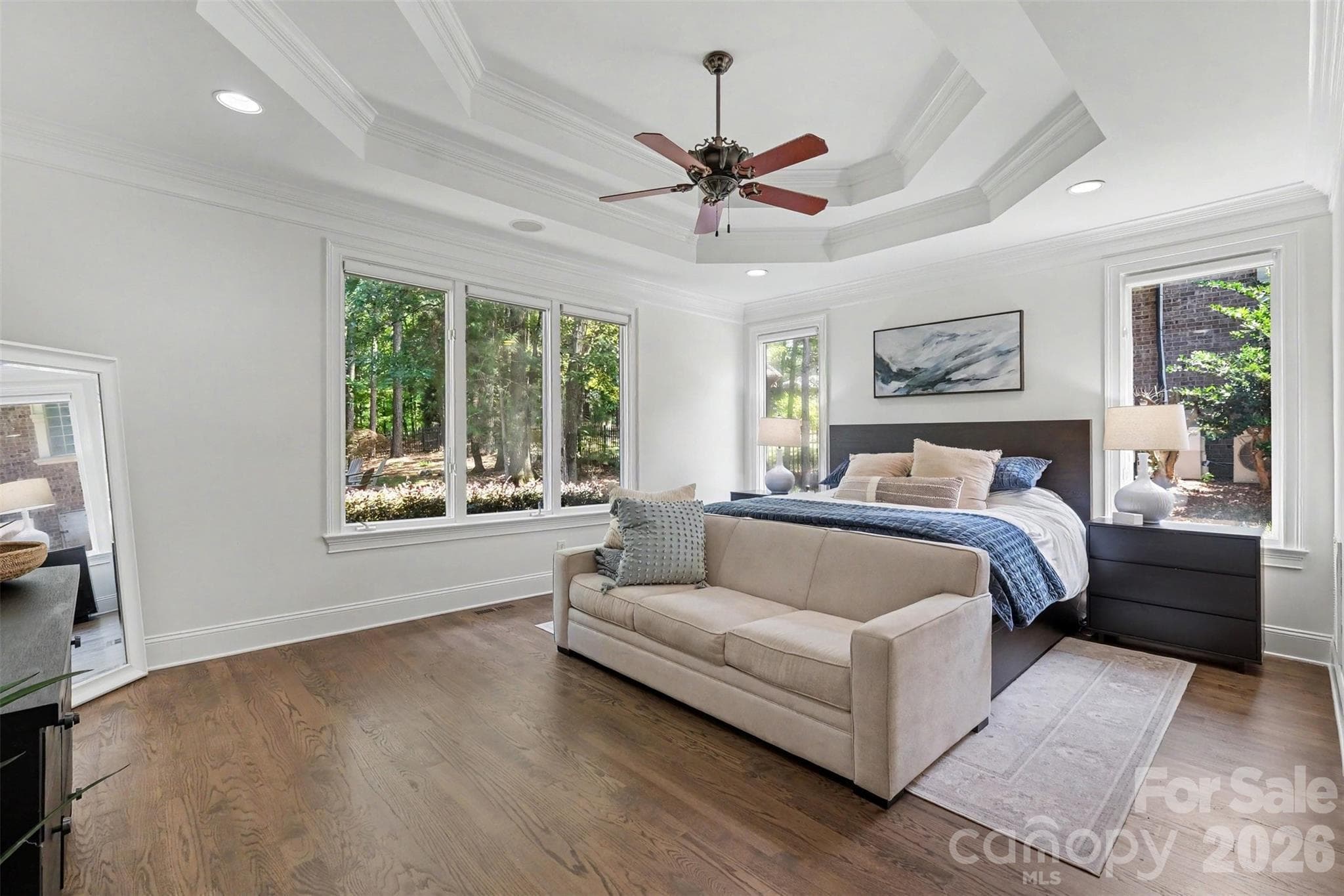 Main level primary suite with decorative double tray ceiling, and 2 separate walk-in closets, one with custom built-ins. - 109 Whiterock Drive, Mount Holly