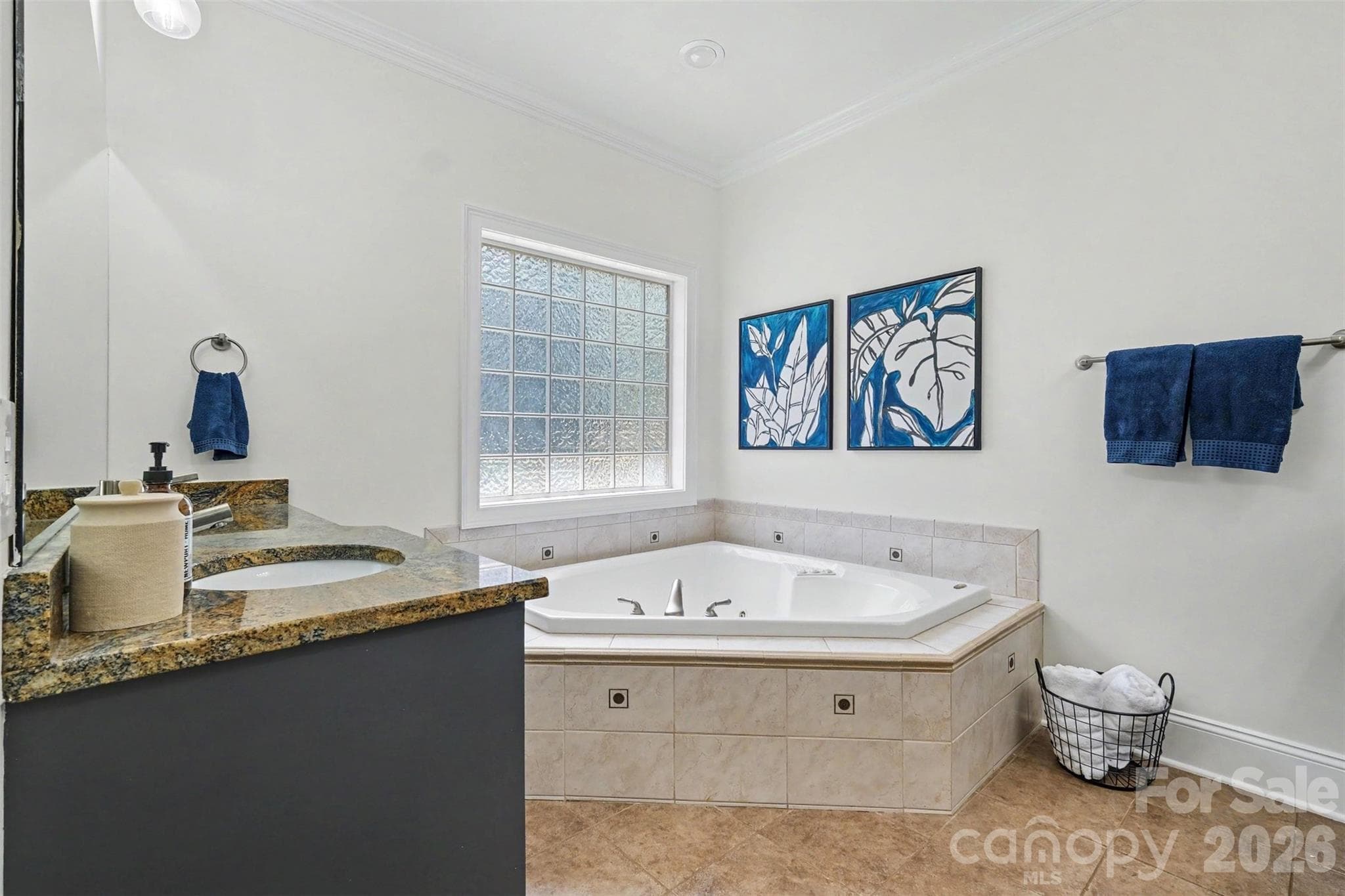 Spa-inspired bath featuring dual vanities with granite countertops, jetted soaking tub, and private water closet. - 109 Whiterock Drive, Mount Holly