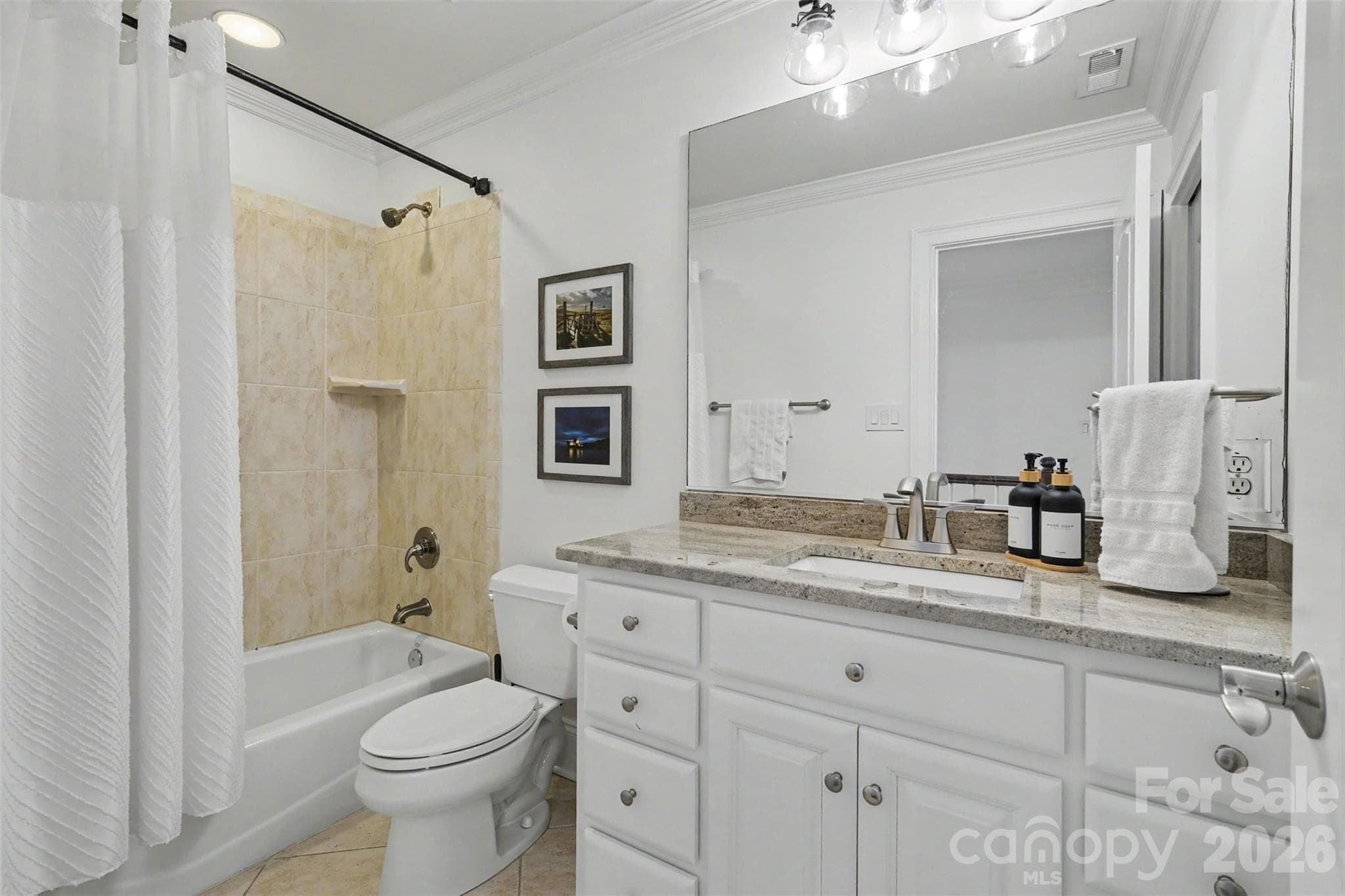 Secondary baths with granite countertops, tile flooring, bathtub with tile surrounsds, and updated fixtures. - 109 Whiterock Drive, Mount Holly