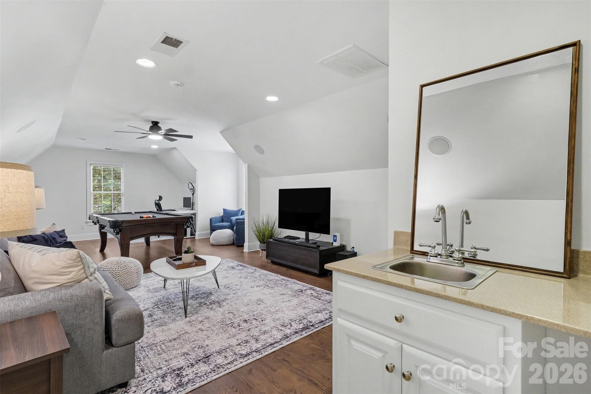 Expansive bonus room with lower cabinet with sink and space for a beverage refrigerator. - 109 Whiterock Drive, Mount Holly