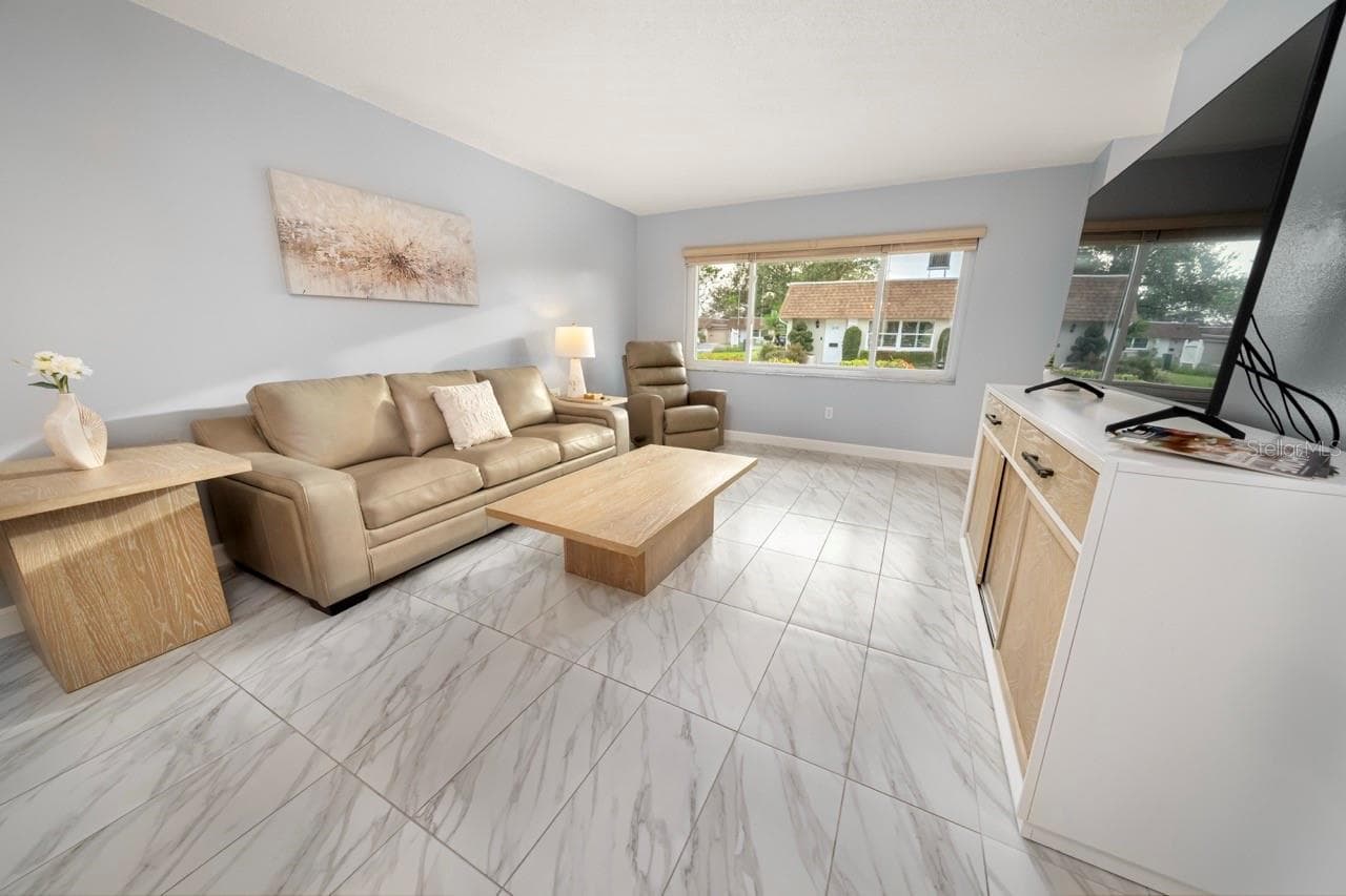 FAMILY ROOM. THIS VILLA STYLE CONDO IS PERFECT FOR ENTERTAINING FAMILY AND FRIENDS - 8235 BURGUNDY DR N #3, PINELLAS PARK