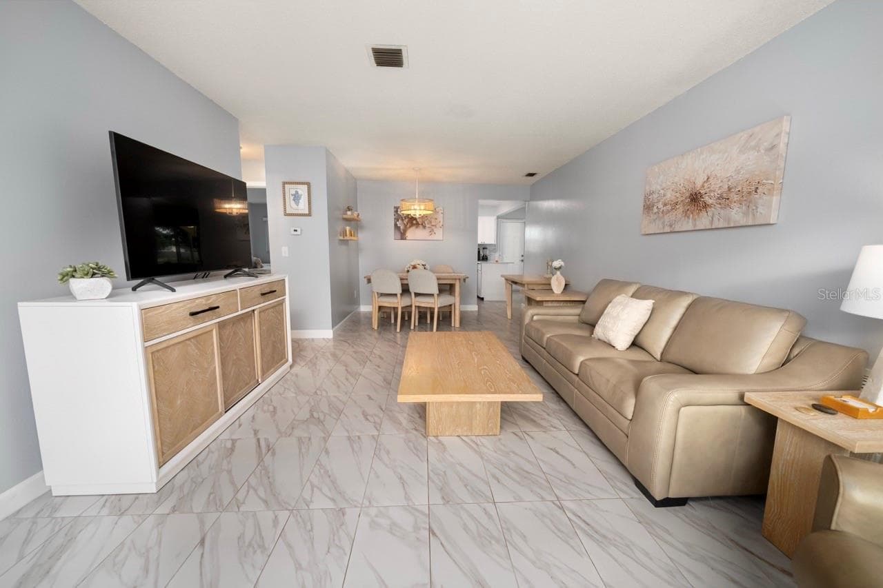 FAMILY ROOM. THIS VILLA STYLE CONDO IS PERFECT FOR ENTERTAINING FAMILY AND FRIENDS - 8235 BURGUNDY DR N #3, PINELLAS PARK