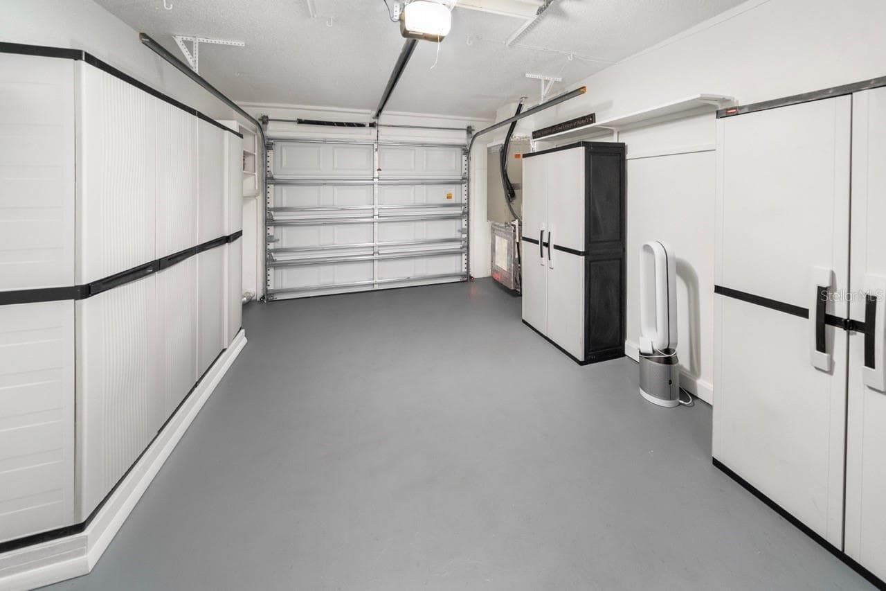 GARAGE. LOTS OF STORAGE. STILL MORE THAN ENOUGH ROOM FOR YOU CAR, SUV, OR TRUCK. - 8235 BURGUNDY DR N #3, PINELLAS PARK