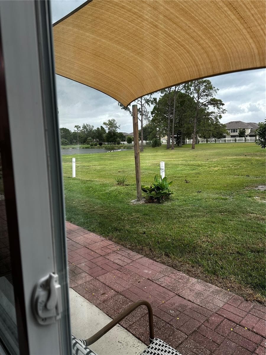 VIEW THROUGH THE LARGE WINDOW FROM YOUR LARGE KITCHEN BREAKFAST NOOK. - 8235 BURGUNDY DR N #3, PINELLAS PARK