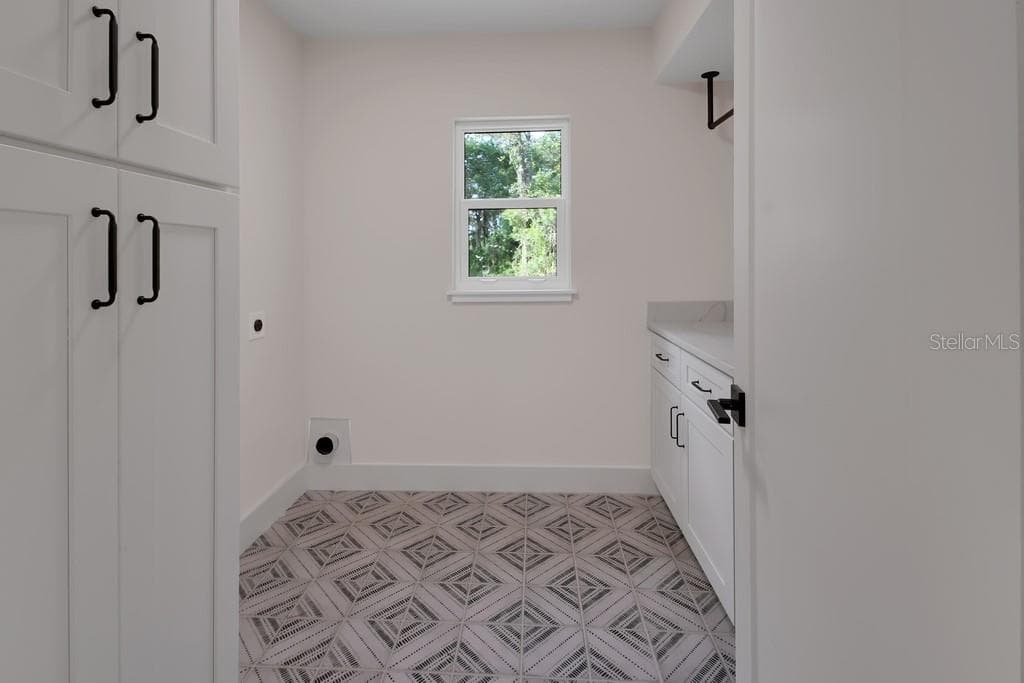 Super laundry room. Folding area and storage - 1530 DEERMOSS LN, DELAND
