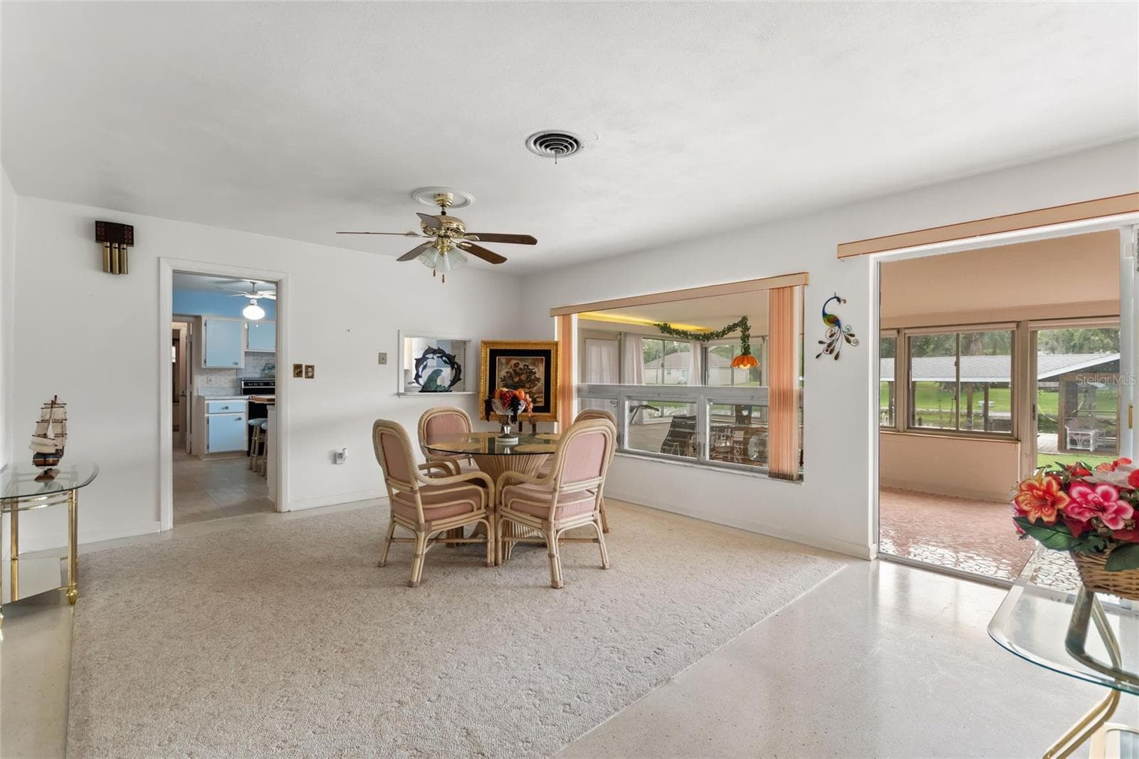 View of family room and informal eating area with view back into kitchen and sun room. - 6197 AMARYLLIS DR, INDIAN LAKE ESTATES