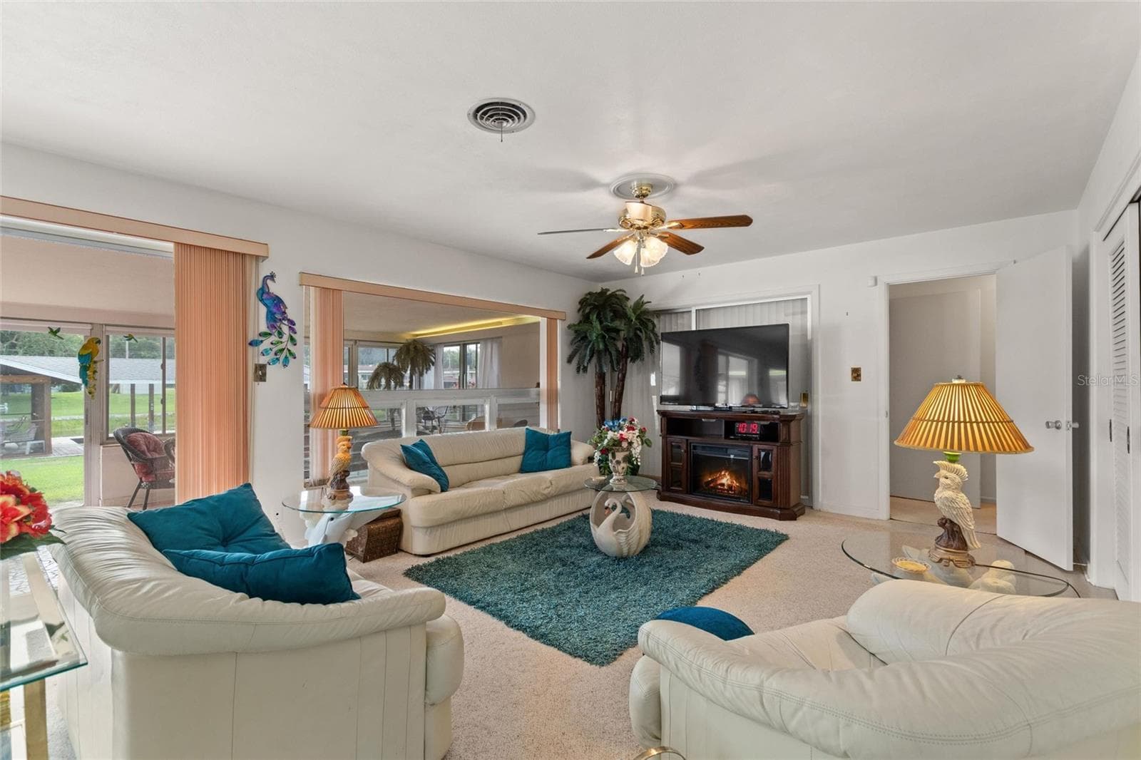 Family room area. Doorway in right rear leads into the bedroom area on the south side of the home. - 6197 AMARYLLIS DR, INDIAN LAKE ESTATES