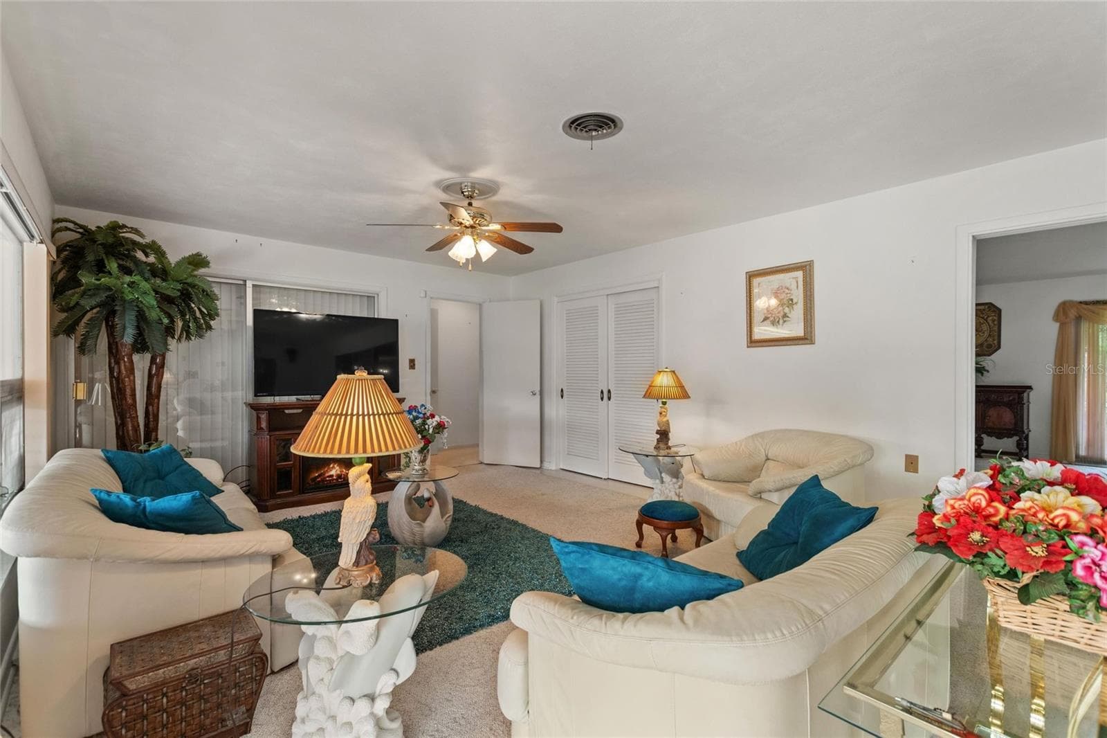 View of family room. The double doors in the back right is a storage closet. This home has LOTS OF STORAGE! - 6197 AMARYLLIS DR, INDIAN LAKE ESTATES