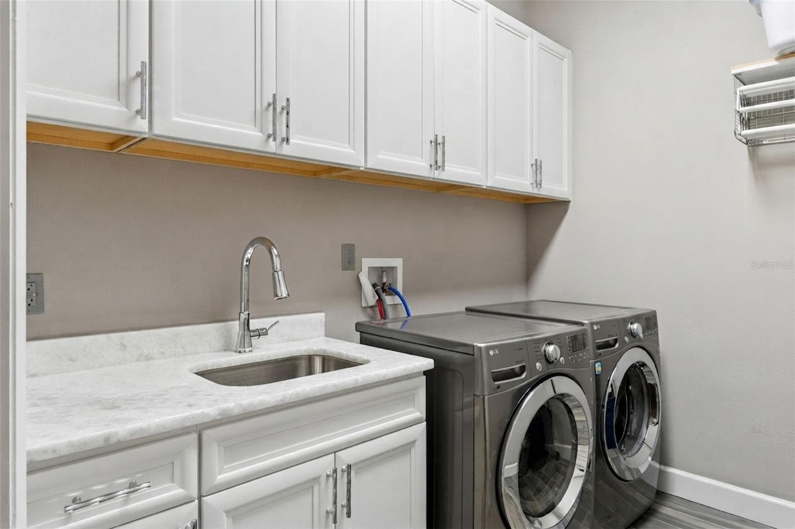 Private Laundry in Primary Suite. Complete with Sink, Cabinets and Drying Racks - 1629 HEMPEL AVE, WINDERMERE