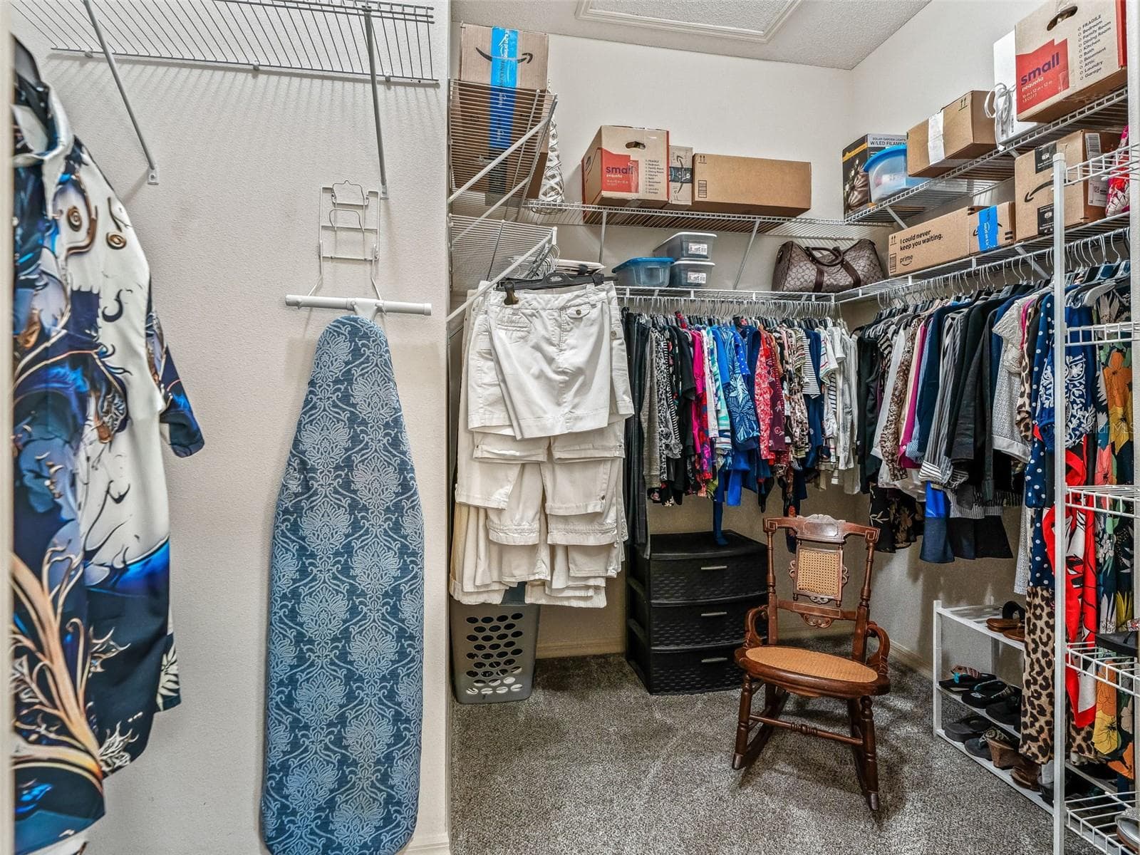 Roomy walk-in closet features extensive shelving and hanging space, providing excellent storage for clothing, shoes, and accessories. - 17946 SE 87TH MELROSE CT, THE VILLAGES