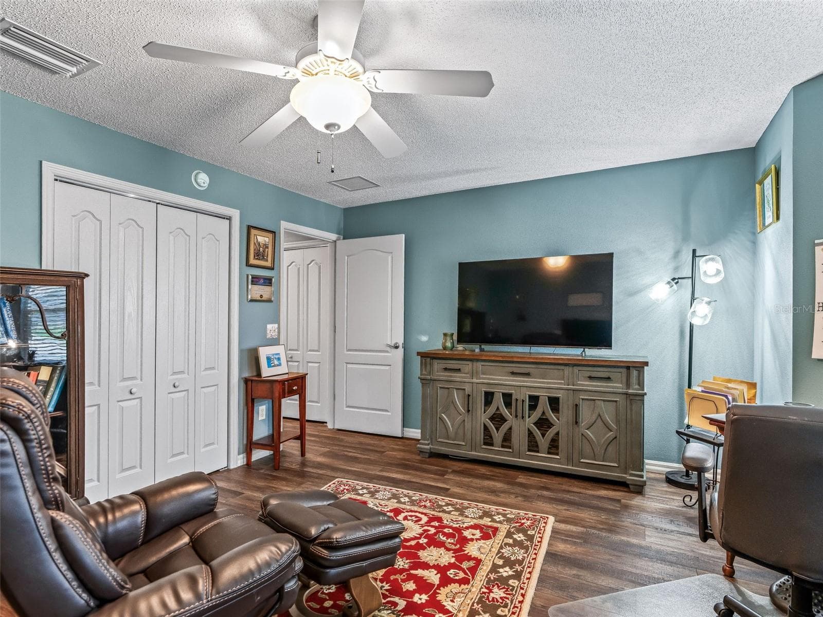 A generous layout, ceiling fan, closet storage, and space for a large television make this room well suited for work, hobbies, guest bedroom, or relaxation. - 17946 SE 87TH MELROSE CT, THE VILLAGES