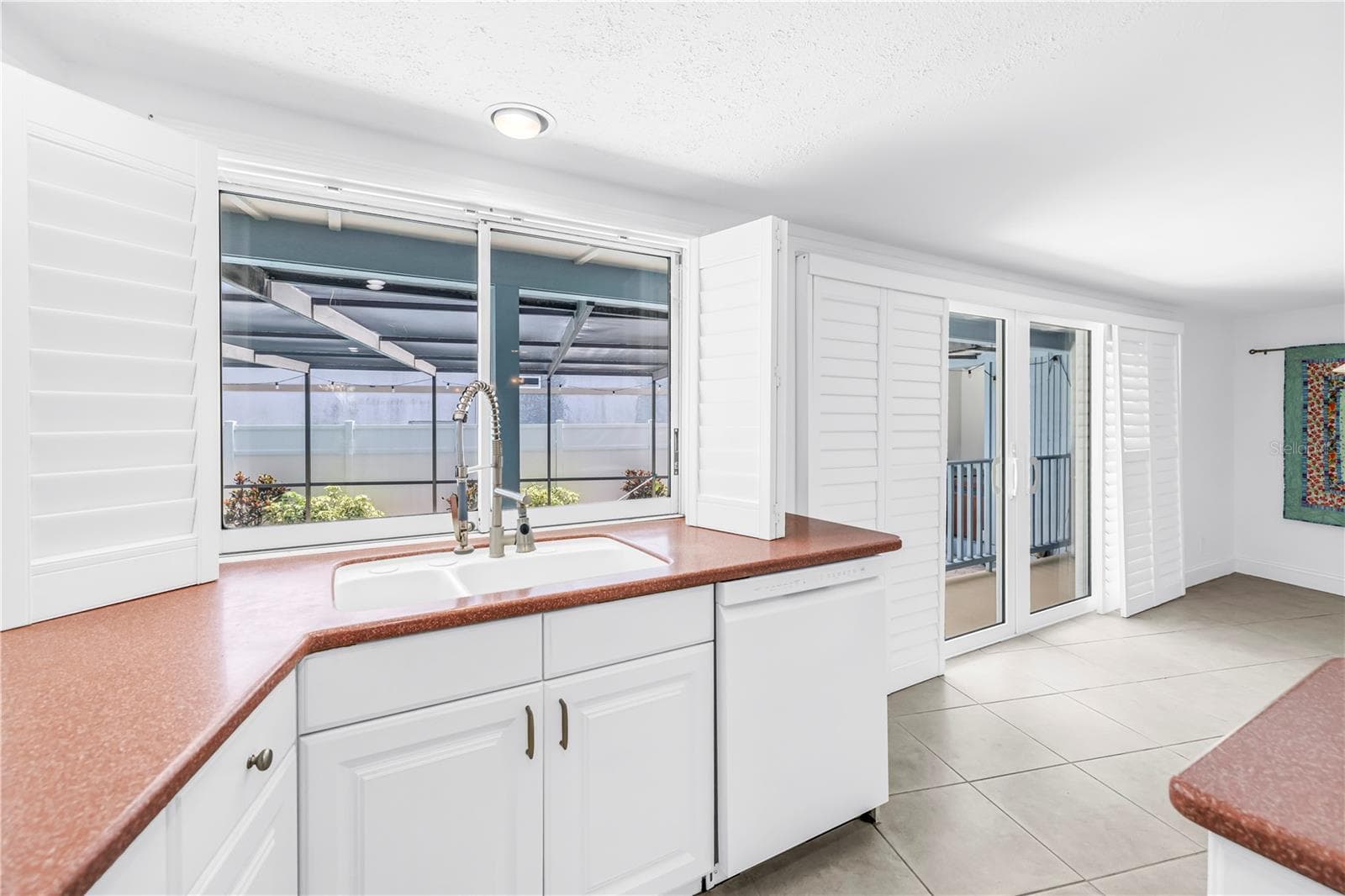 Kitchen sink overlooks pool - 3000 HERON PL, CLEARWATER