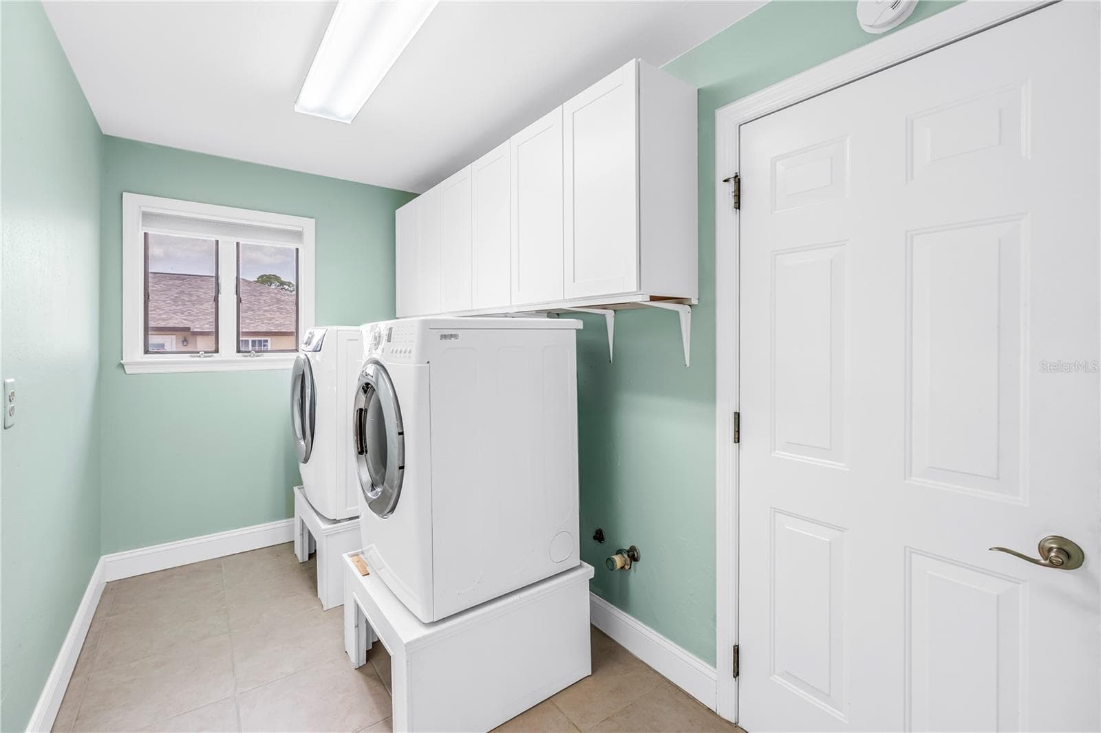 Large indoor laundry with storage - door leads to garage - 3000 HERON PL, CLEARWATER