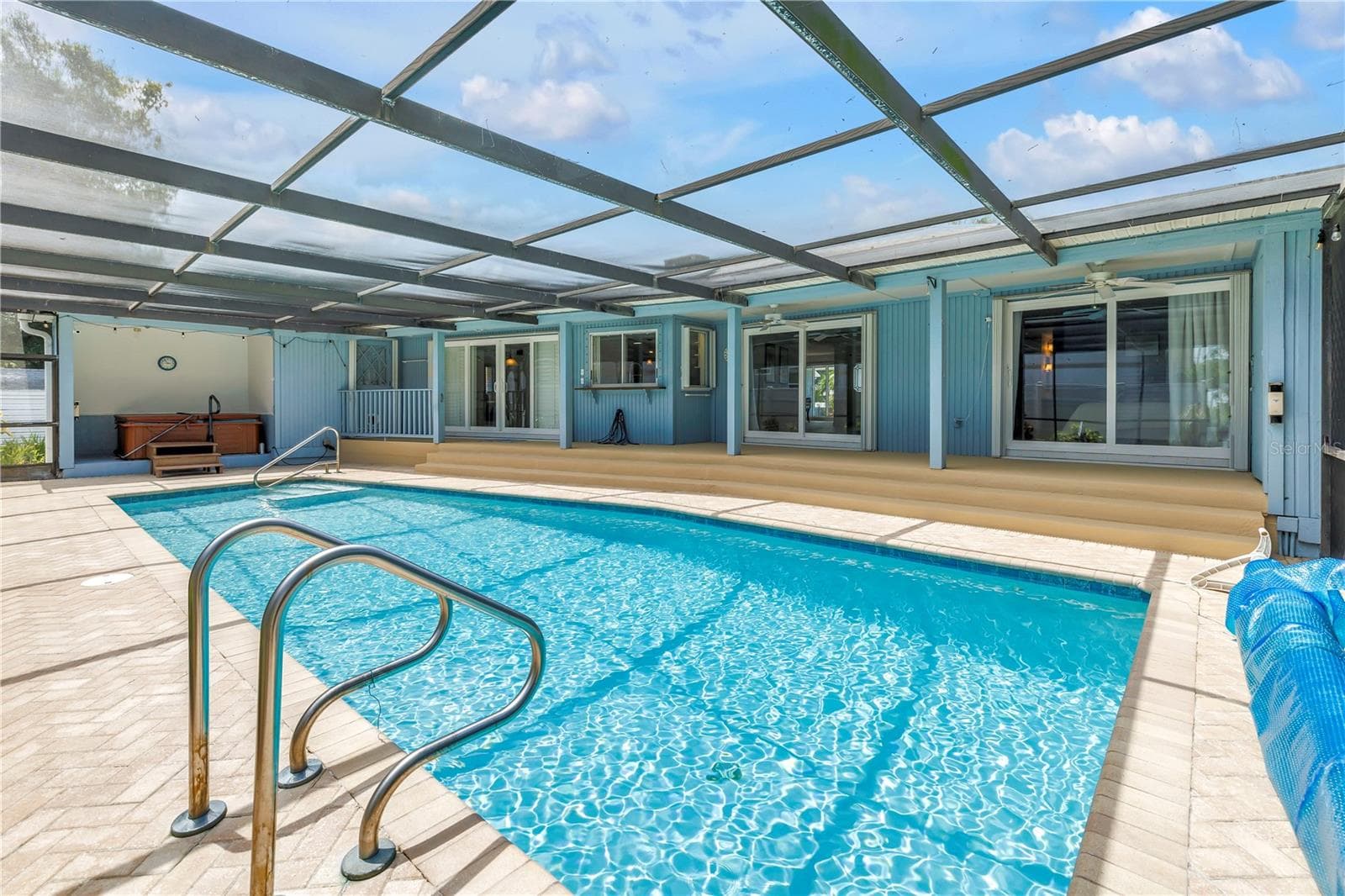Rear view of pool & home - 3000 HERON PL, CLEARWATER