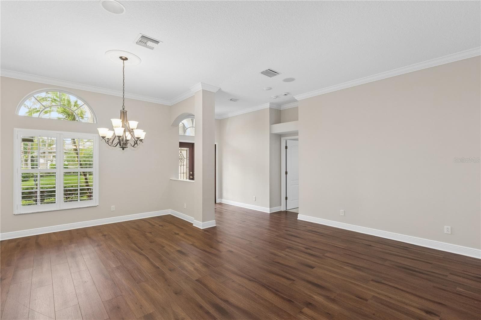 The grand entry welcomes you with beautiful formal living room and dining room, offering an elegant space to gather with family, entertain guests, or celebrate life's special moments. - 26920 WINGED ELM DR, WESLEY CHAPEL