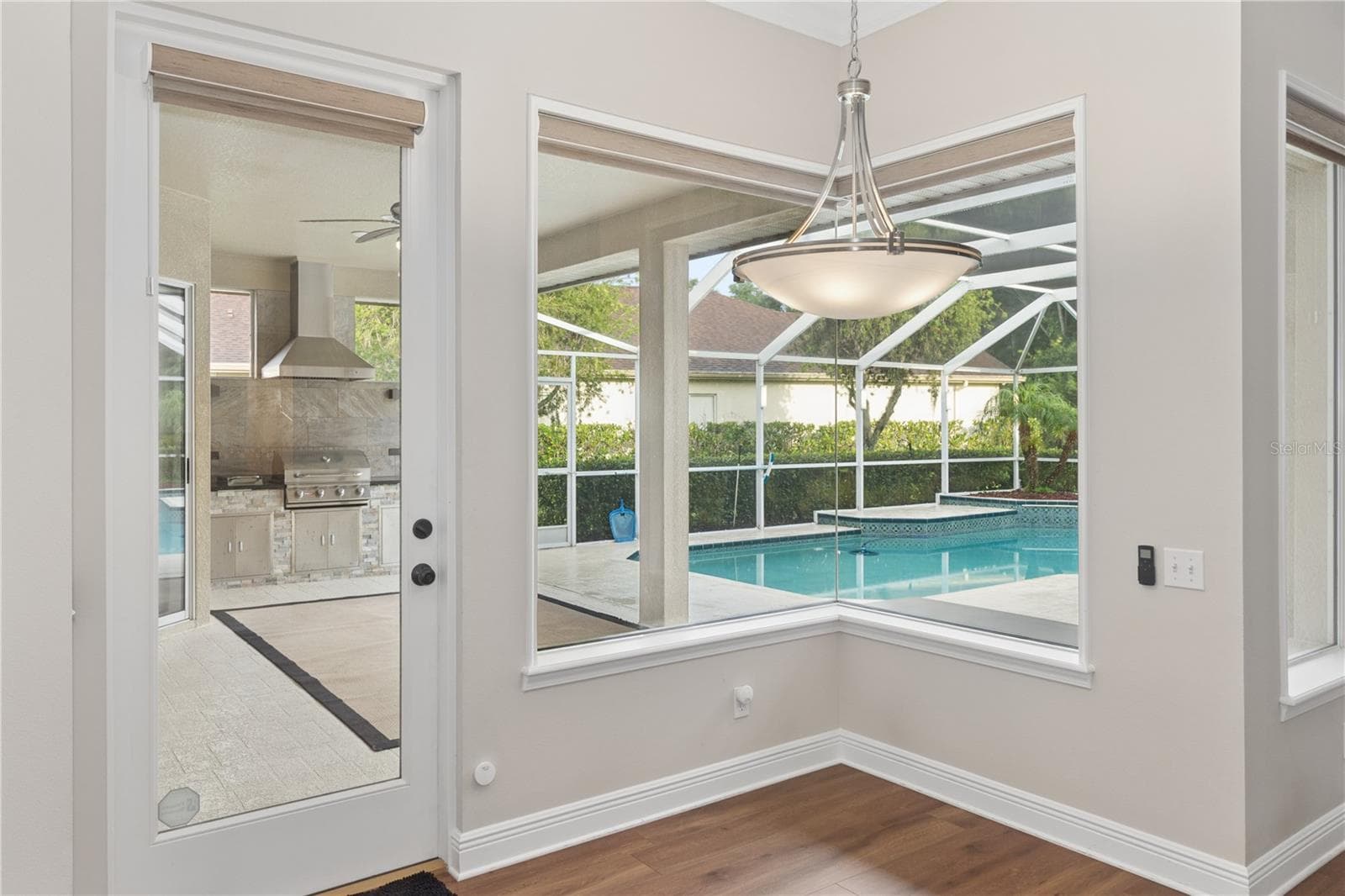 Enjoy casual dining in the bright breakfast area, complete with pool views and direct access to the screened lanai. - 26920 WINGED ELM DR, WESLEY CHAPEL