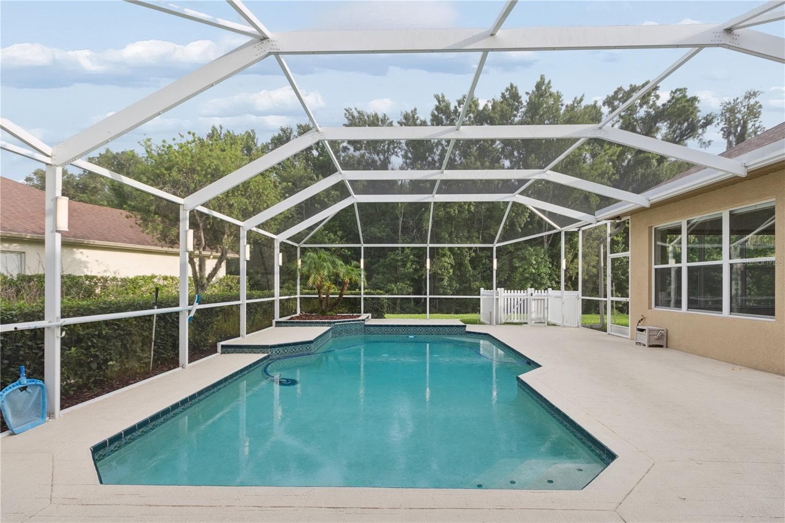 Pet lovers will appreciate the dedicated dog run, complete with a built-in doggie door that provides convenient access to a private outdoor area. - 26920 WINGED ELM DR, WESLEY CHAPEL