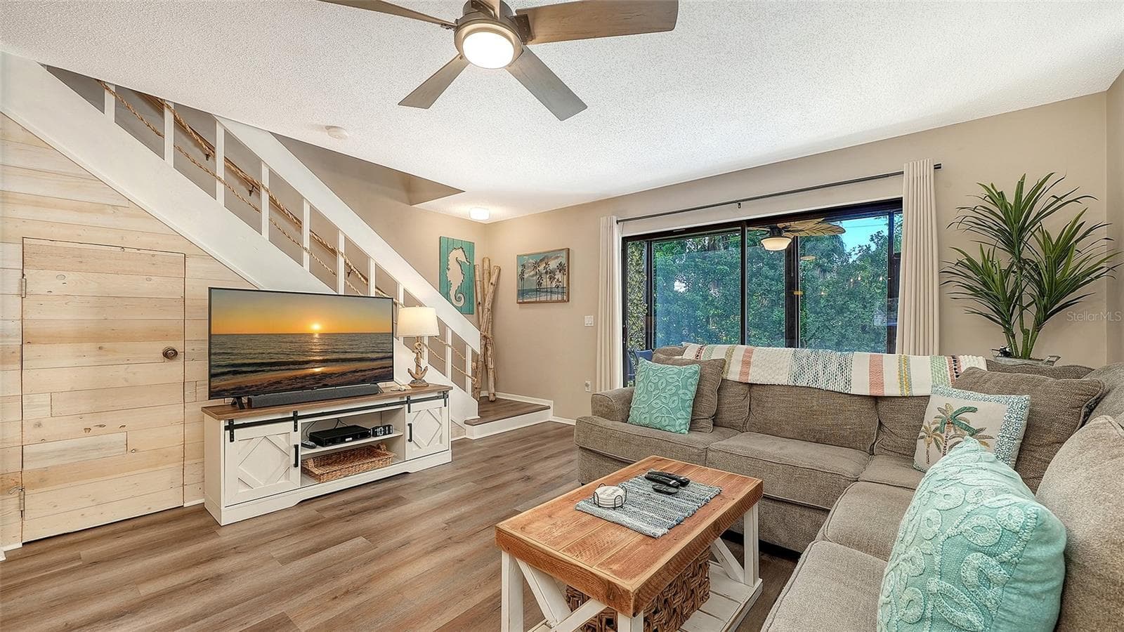 Living Room and storge closet under the staircase. - 1646 STICKNEY POINT RD #101, SARASOTA
