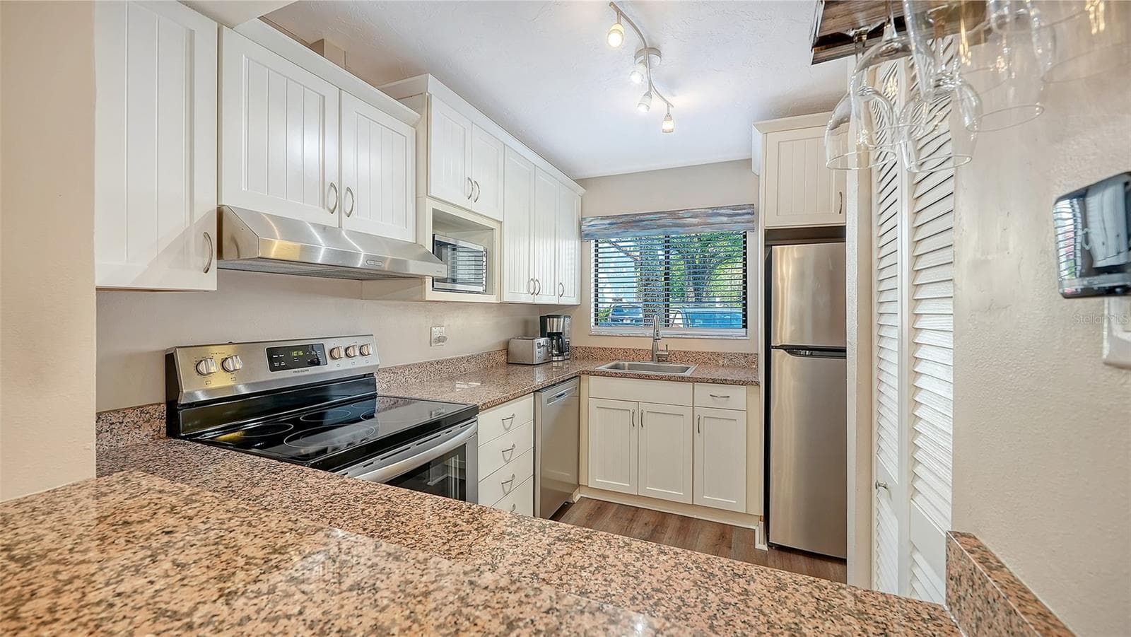 Kitchen with new granite countertops. - 1646 STICKNEY POINT RD #101, SARASOTA