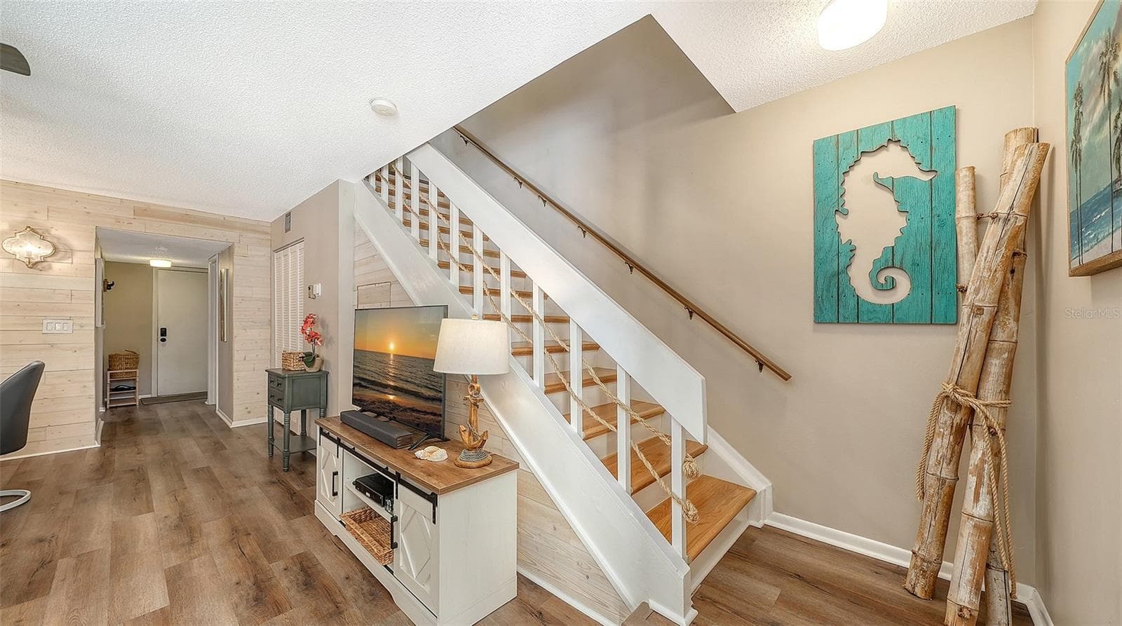 Entry Door, storage/mechanical closet, storage closet under the stairway, newly redone stairway. - 1646 STICKNEY POINT RD #101, SARASOTA