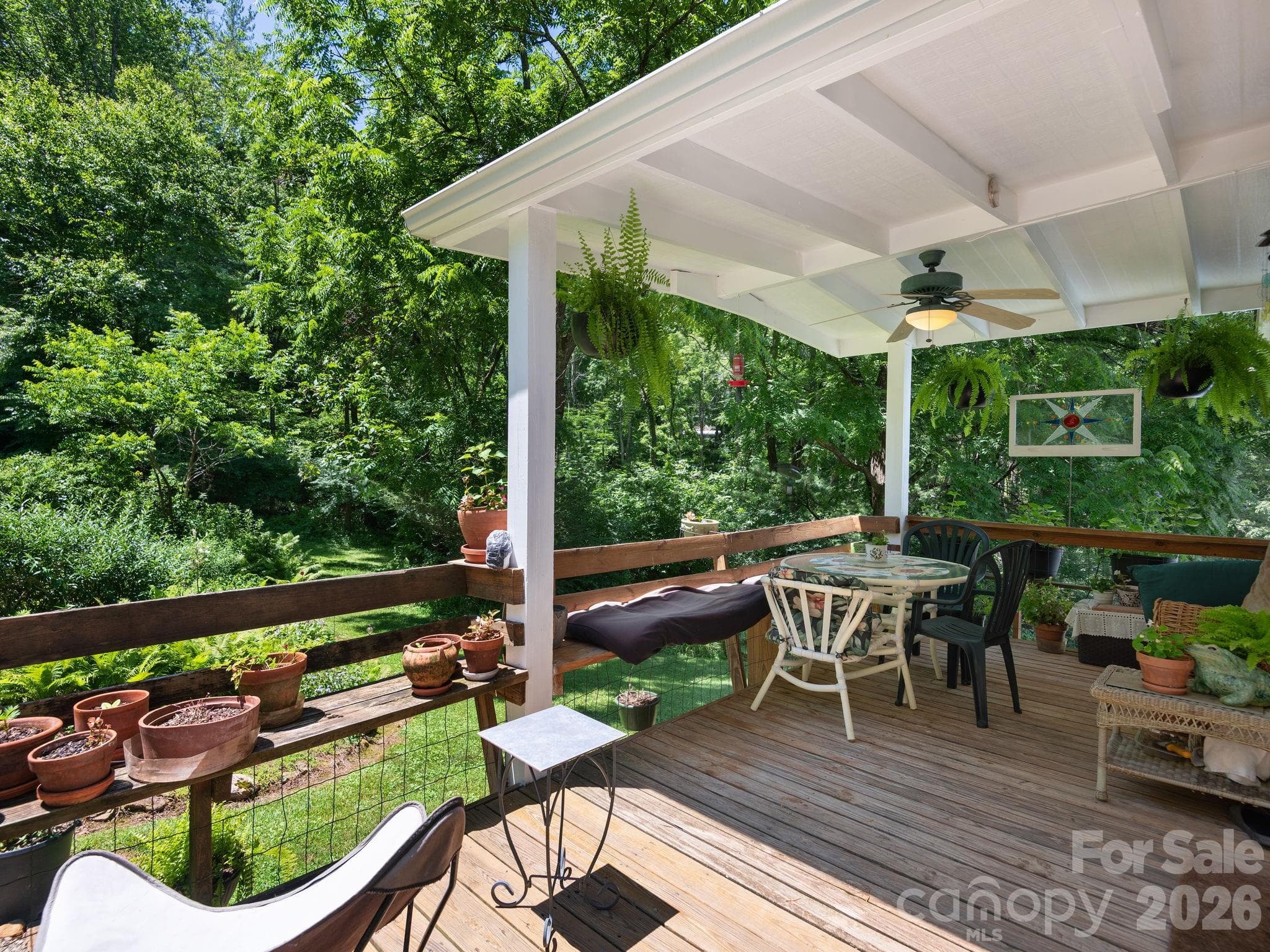 Covered porch off the kitchen overlooks a gentle stream and the stunning gardens. Once you sit here... you won't want to leave! - 46 Perennial Ridge, Weaverville