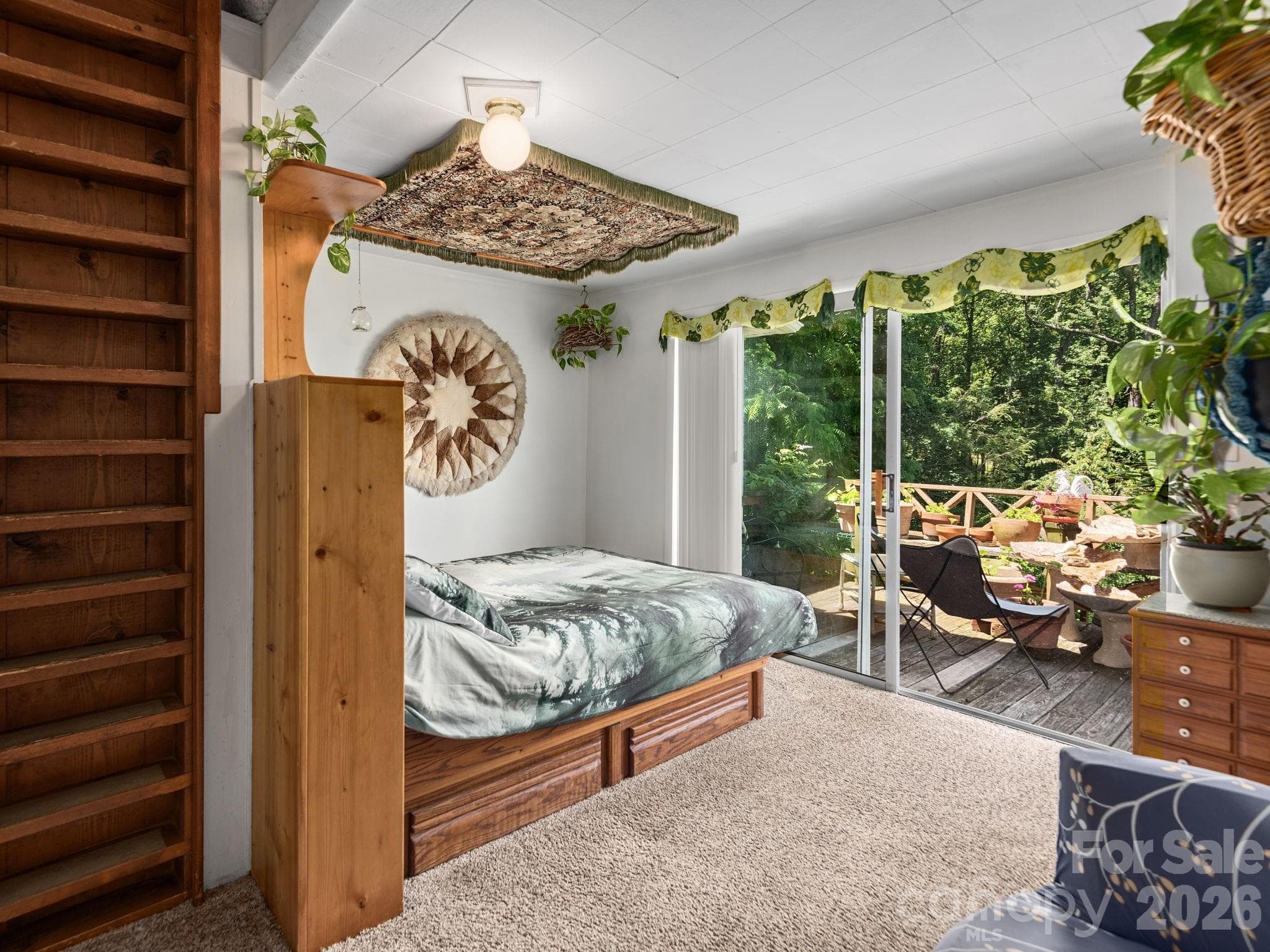 Primary bedroom has direct deck access and ladder leading to loft area - 46 Perennial Ridge, Weaverville