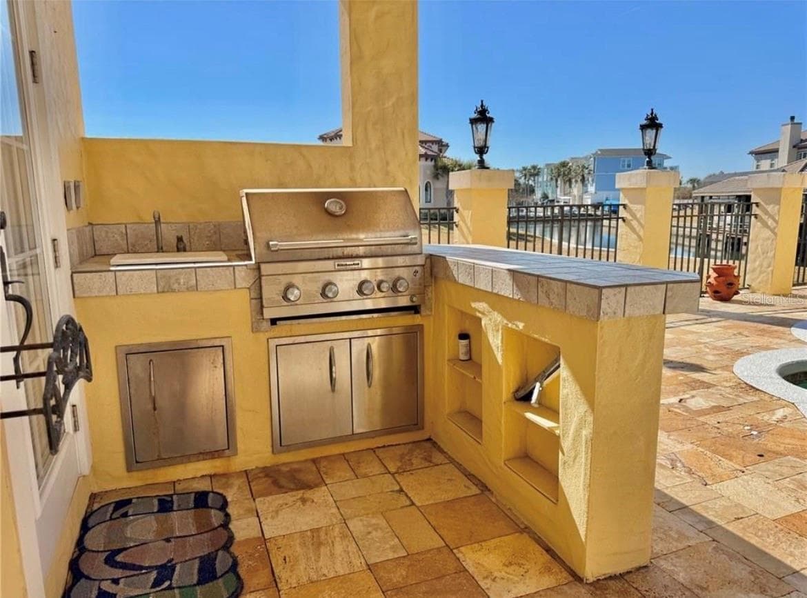 Outdoor kitchen with gas grill and bar sink - 88 HIDDEN CV, FLAGLER BEACH