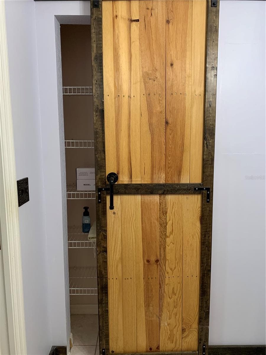 Linen closet in master bath with barn door - 6369 SW 117TH LOOP, OCALA