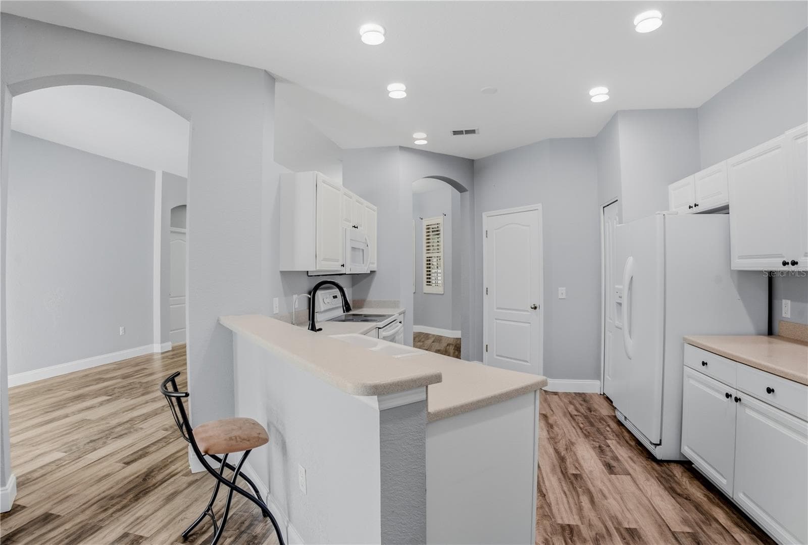 KITCHENWITH WALK THROUGH TO DINING AREA AND LIVING ROOM ENTRANCE TO LEFT - 1710 BROOKSTONE WAY, PLANT CITY