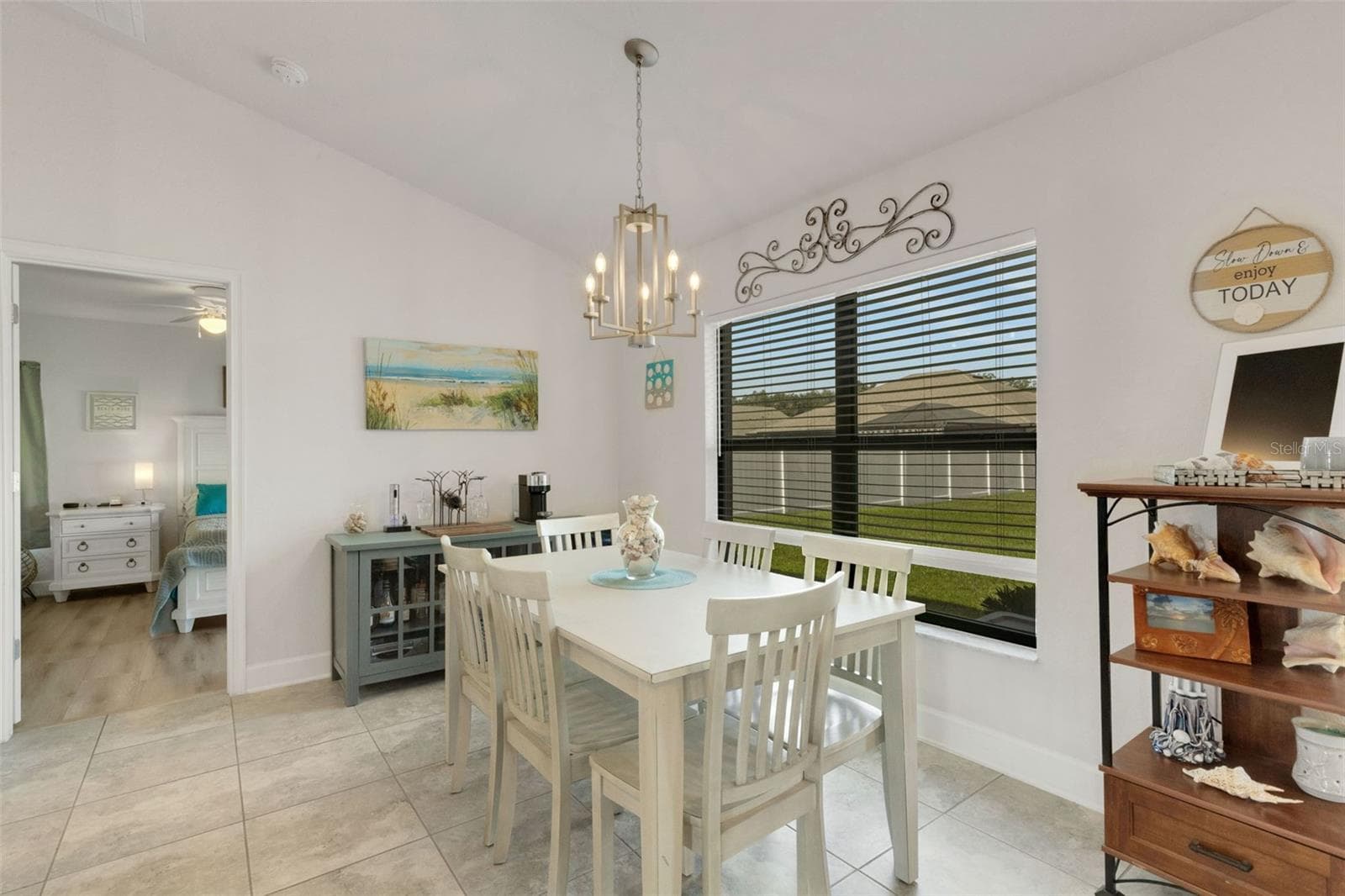 The dining space in integrated into the main living area and has lovely picture window overlooking the lush green backyard. - 220 HERITAGE PARK LN, MULBERRY