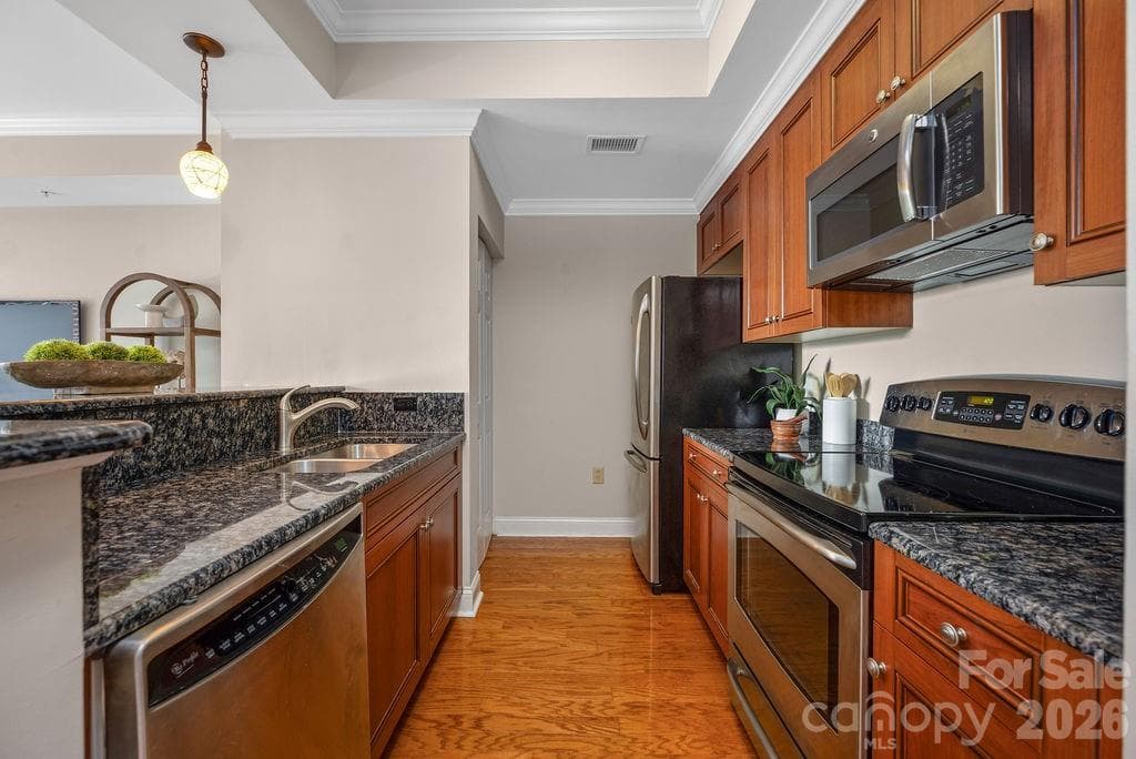 Kitchen with granite counter tops and stainless steel appliances - 300 W 5th Street, Charlotte