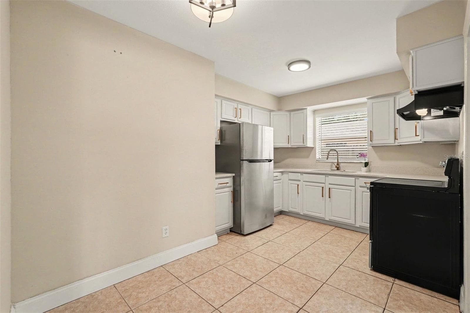 The kitchen is both stylish and functional, with plenty of cabinet and counter space. - 5733 66TH LN N, ST PETERSBURG