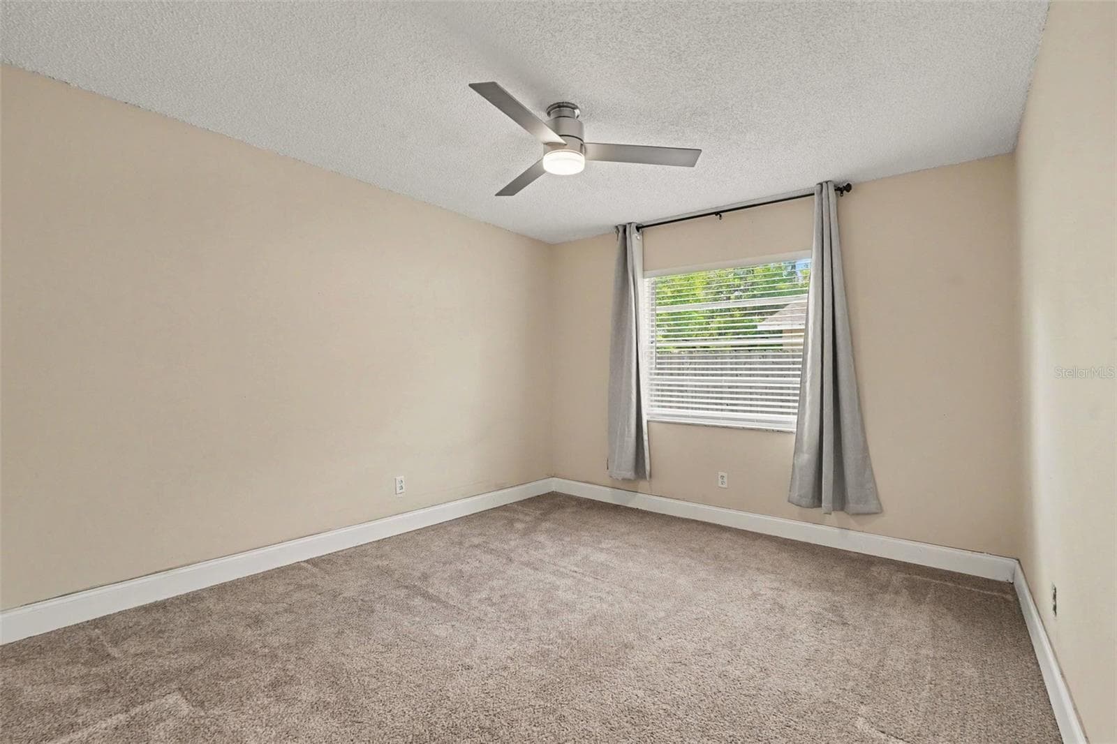 The primary bedroom offers a peaceful retreat with room for your personal style. - 5733 66TH LN N, ST PETERSBURG