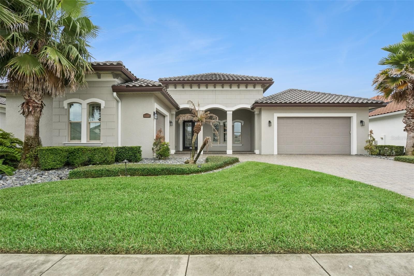 Front exterior with manicured landscaping - 1417 OIL LAMP CV, LAKE MARY