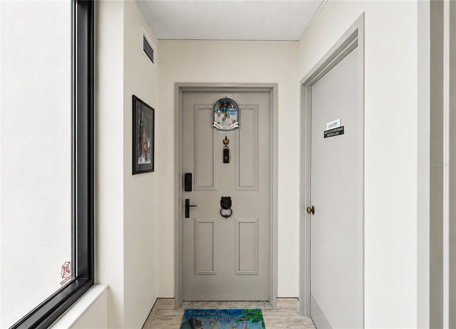 Entry way - notice the laundry room right next door. - 3051 S ATLANTIC AVE #V060, DAYTONA BEACH SHORES