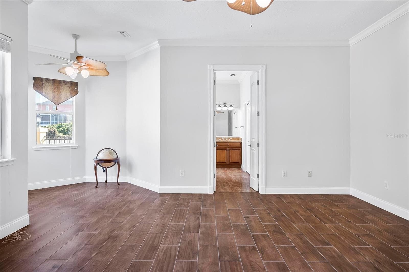 Primary bedroom with sitting area overlooking courtyard - 88 HIDDEN CV, FLAGLER BEACH