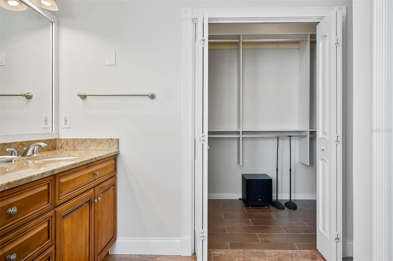 Primary bedroom walk-in closet off primary bathroom - 88 HIDDEN CV, FLAGLER BEACH