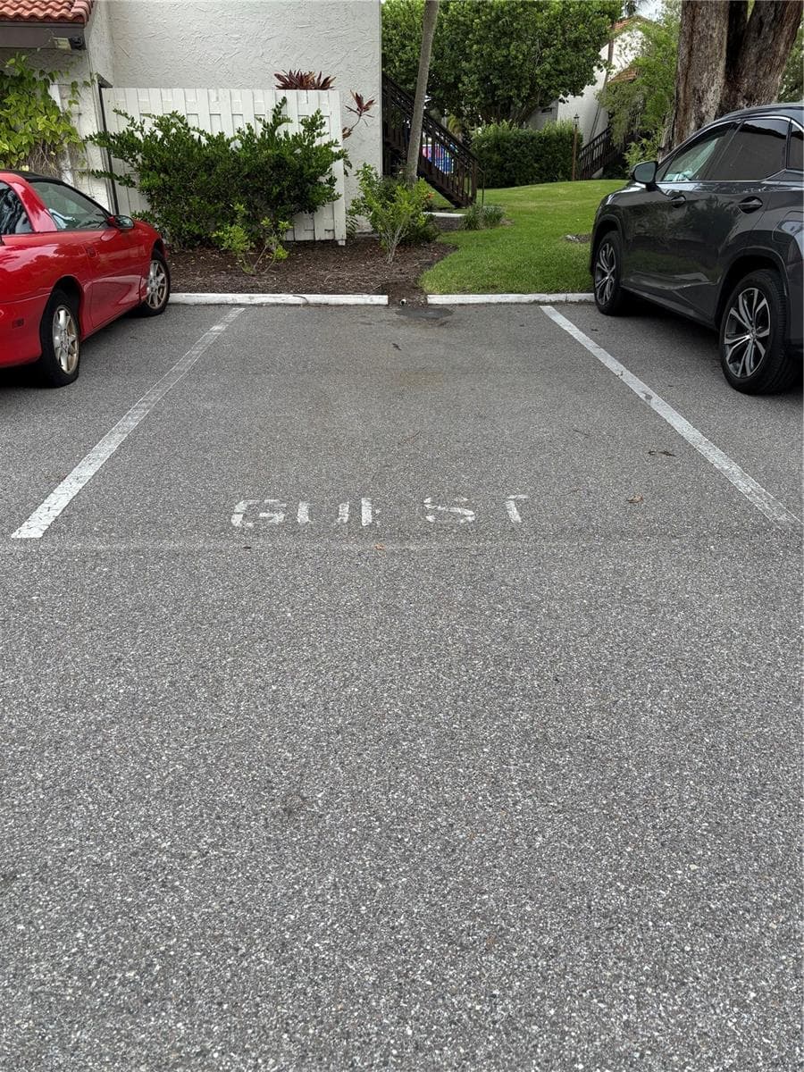 Multiple guest parking spaces directly across the driveway from the unit entry door. - 1646 STICKNEY POINT RD #101, SARASOTA