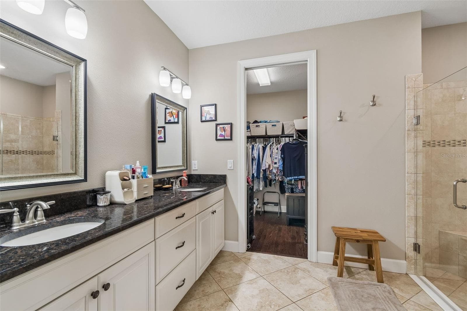 Primary ensuite, dual sinks, glass enclosed shower with bench and large walk-in closet - 11503 CALLISIA DR, ODESSA