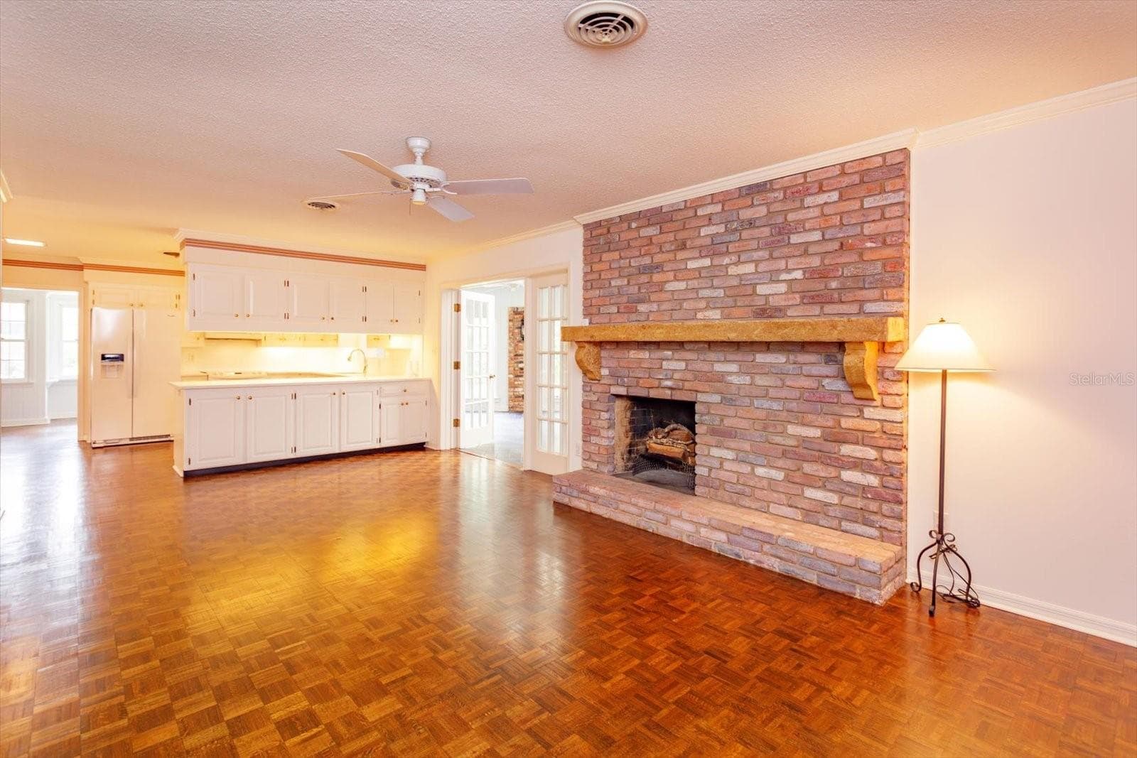 Family Room is open to Kitchen and has custom mantle over brick fire place - 5019 GRAN LAC AVE, ORLANDO