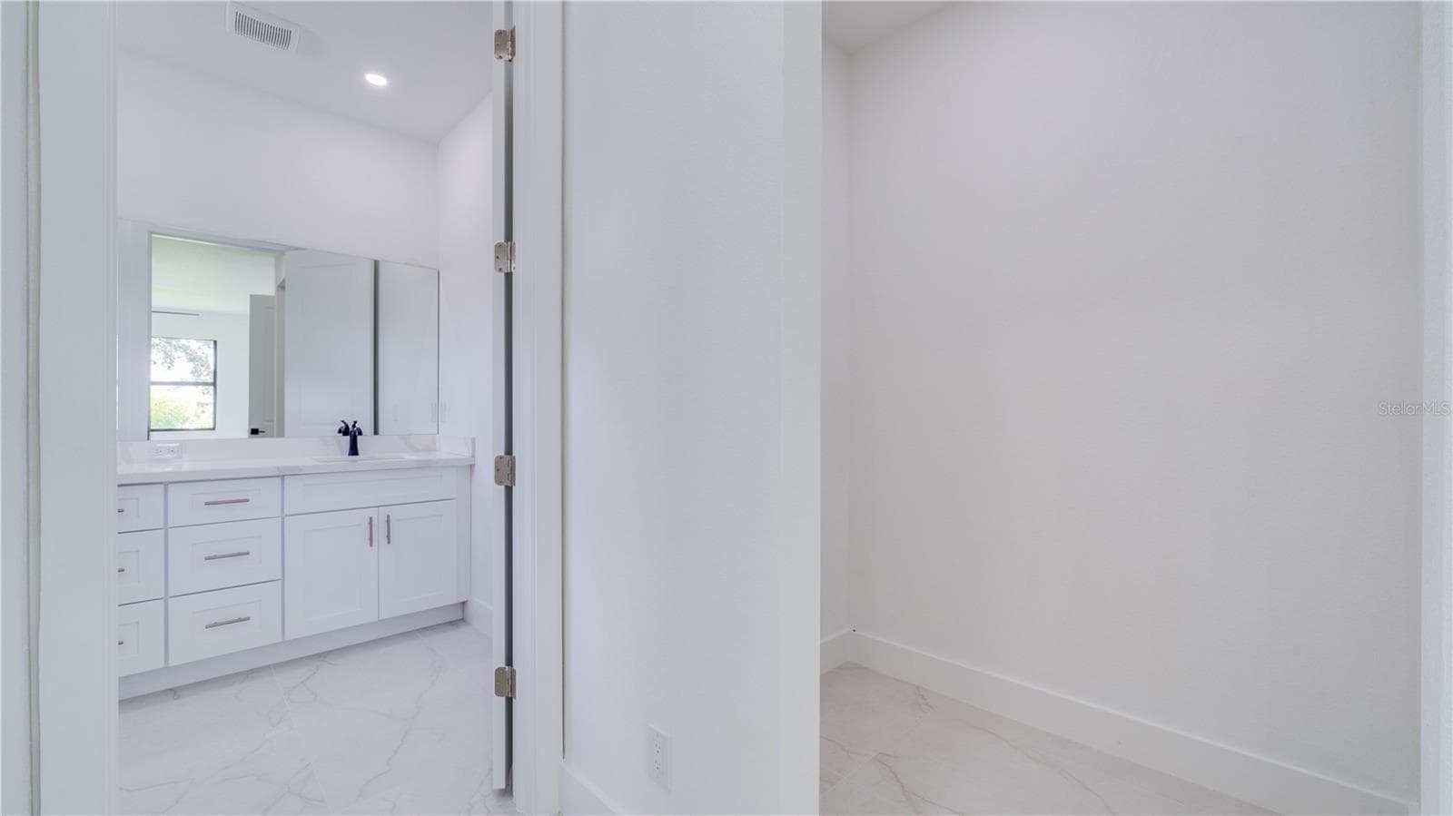 A view leading to the en-suite from the hallway. Closet show to the right. - 2713 8TH ST W, LEHIGH ACRES