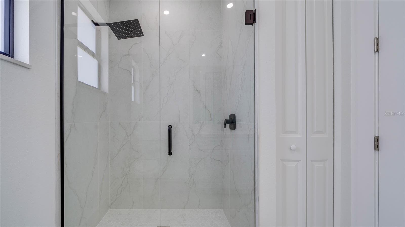 Guest bathroom all tile walk-in rain shower. - 2713 8TH ST W, LEHIGH ACRES