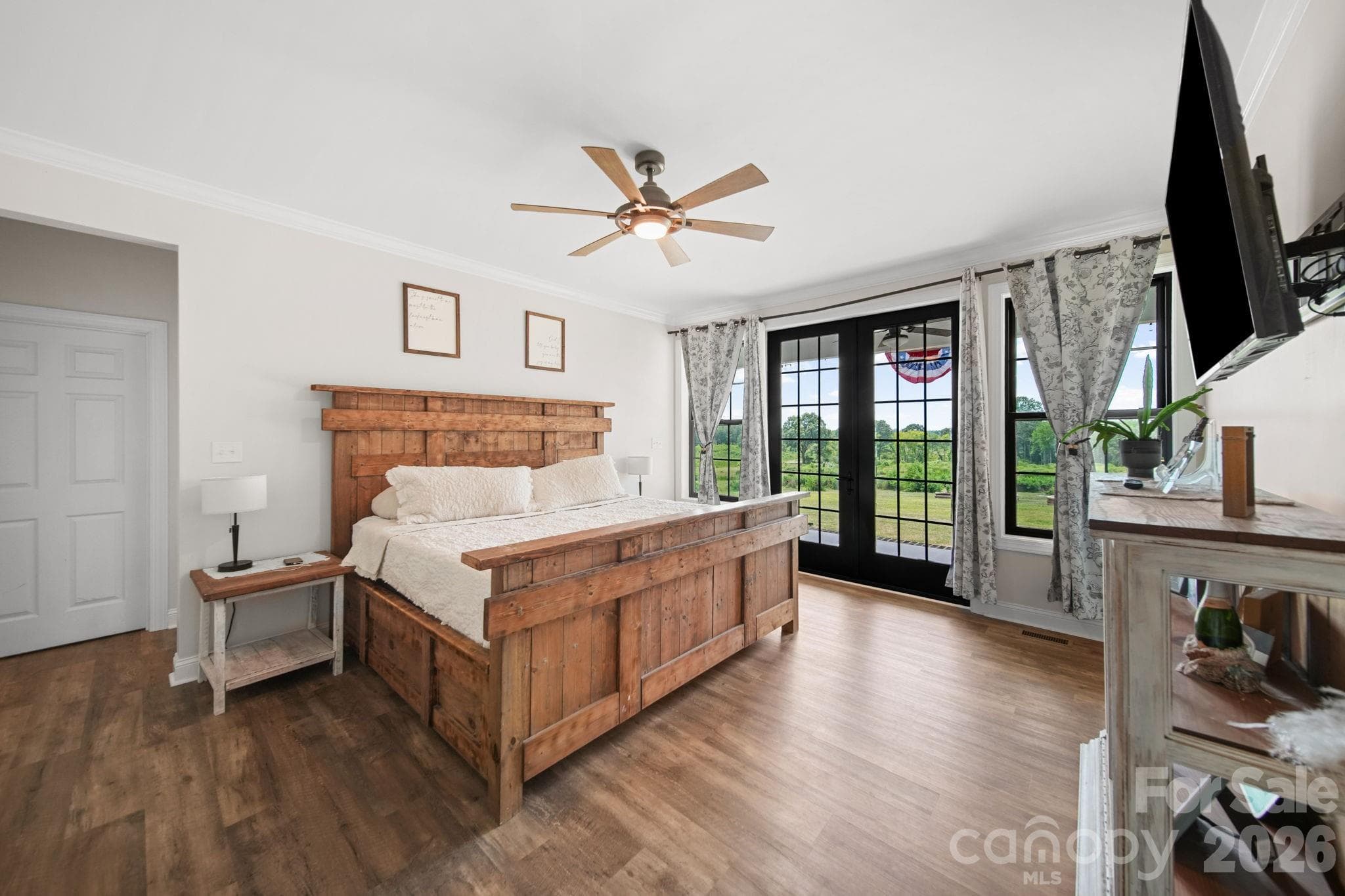 Main level primary bedroom suite opens to the back porch - 1726 Old Cheraw Highway, Rockingham