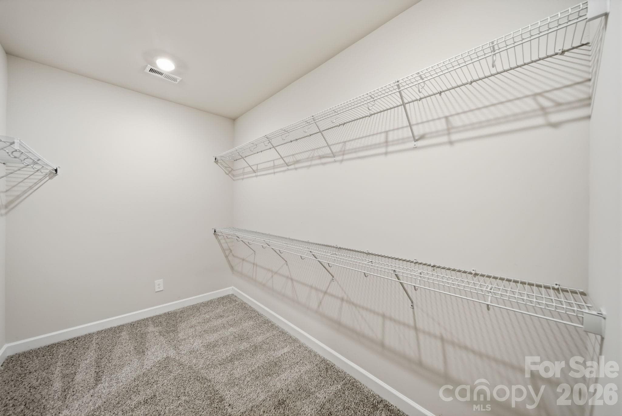 spacious walk in closet for primary bedroom - 6220 Barcelona Way, Charlotte