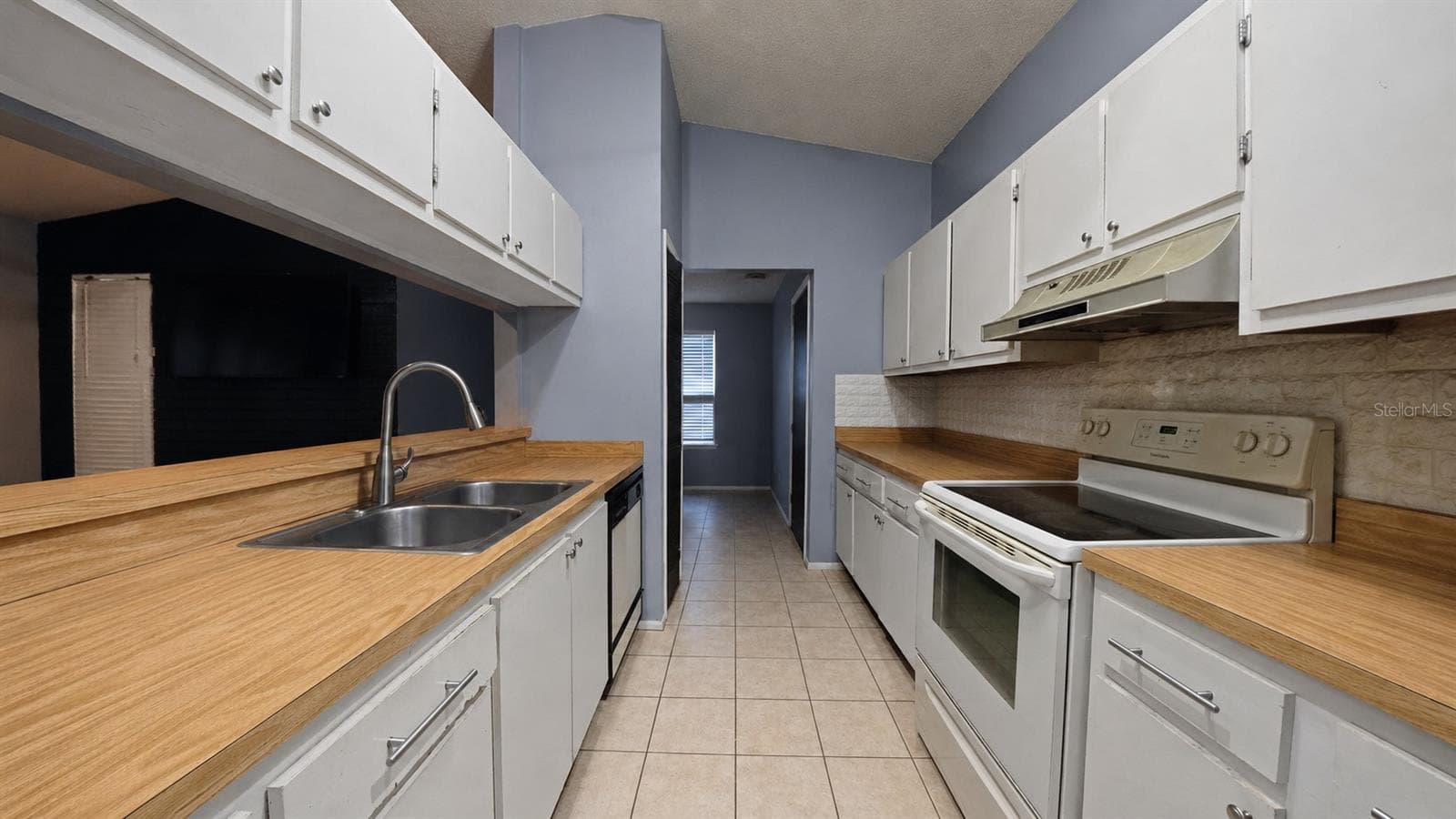 Kitchen with wood countertops and white cabinetry - 257 CLEMENS CT, ORLANDO