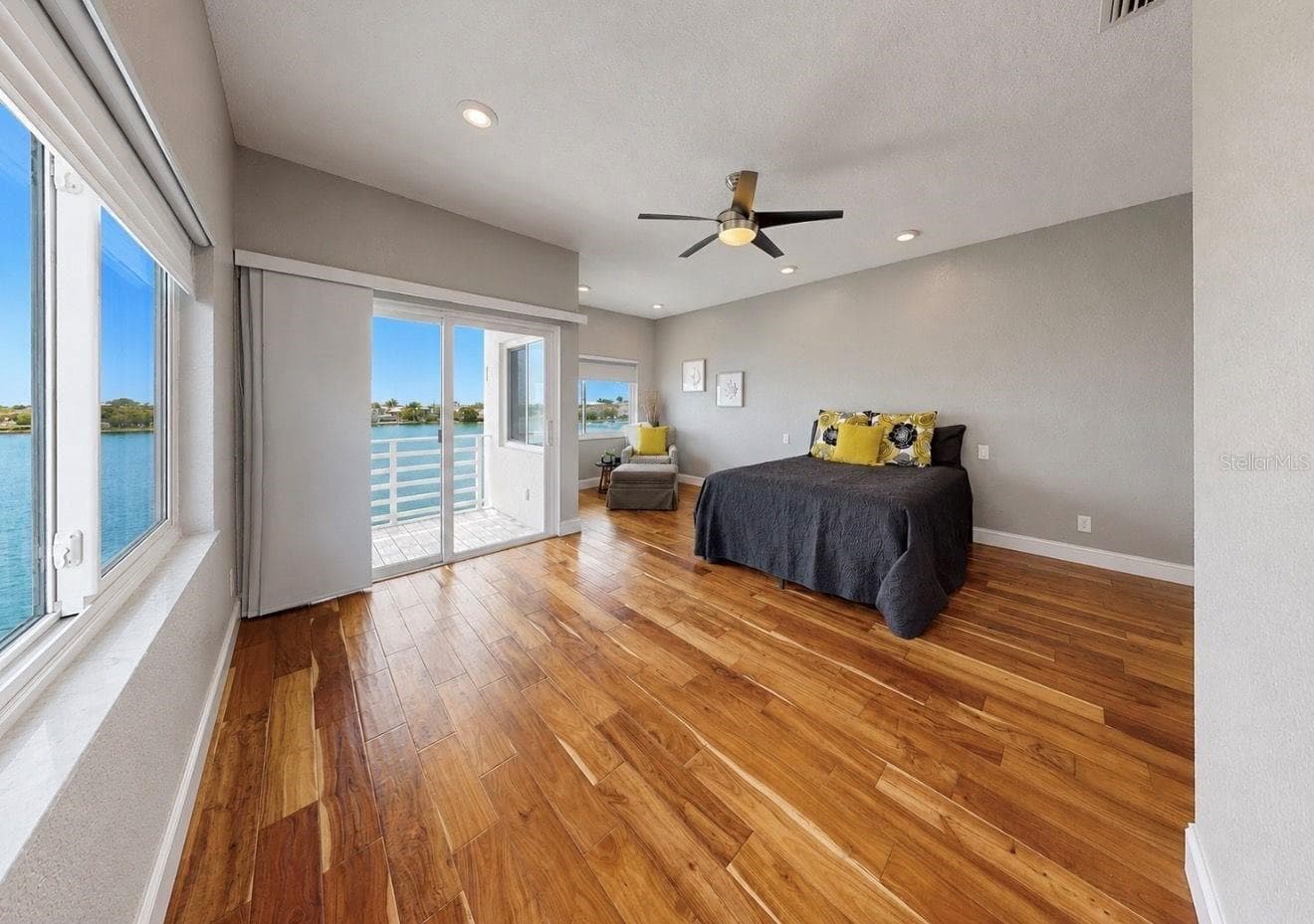 Primary bedroom with 2 walk-in closets and private balcony overlooking the Bay - 4639 MIRABELLA CT, ST PETE BEACH