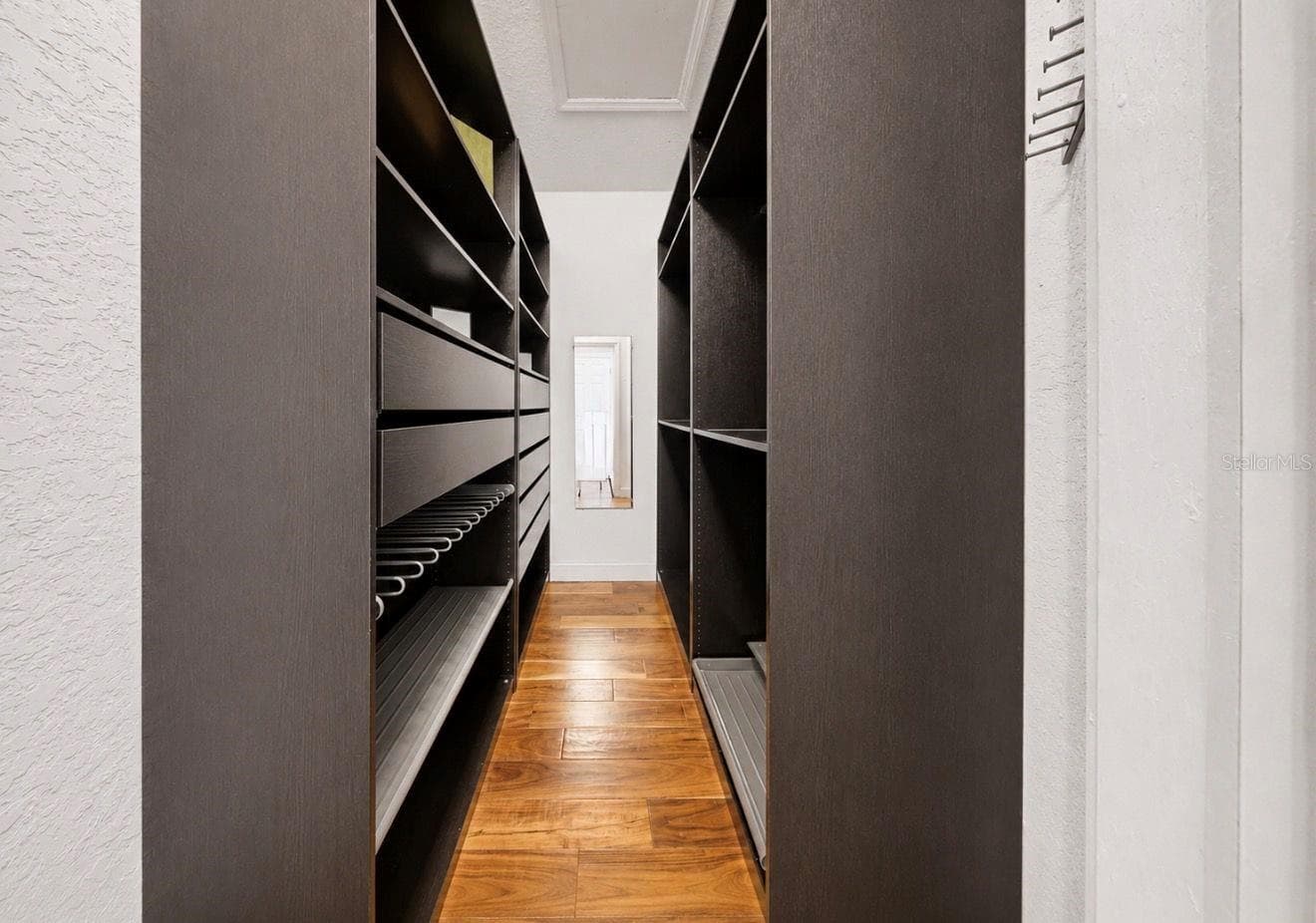 Custom closet system in one of the walk-in primary bedrooms closets - 4639 MIRABELLA CT, ST PETE BEACH