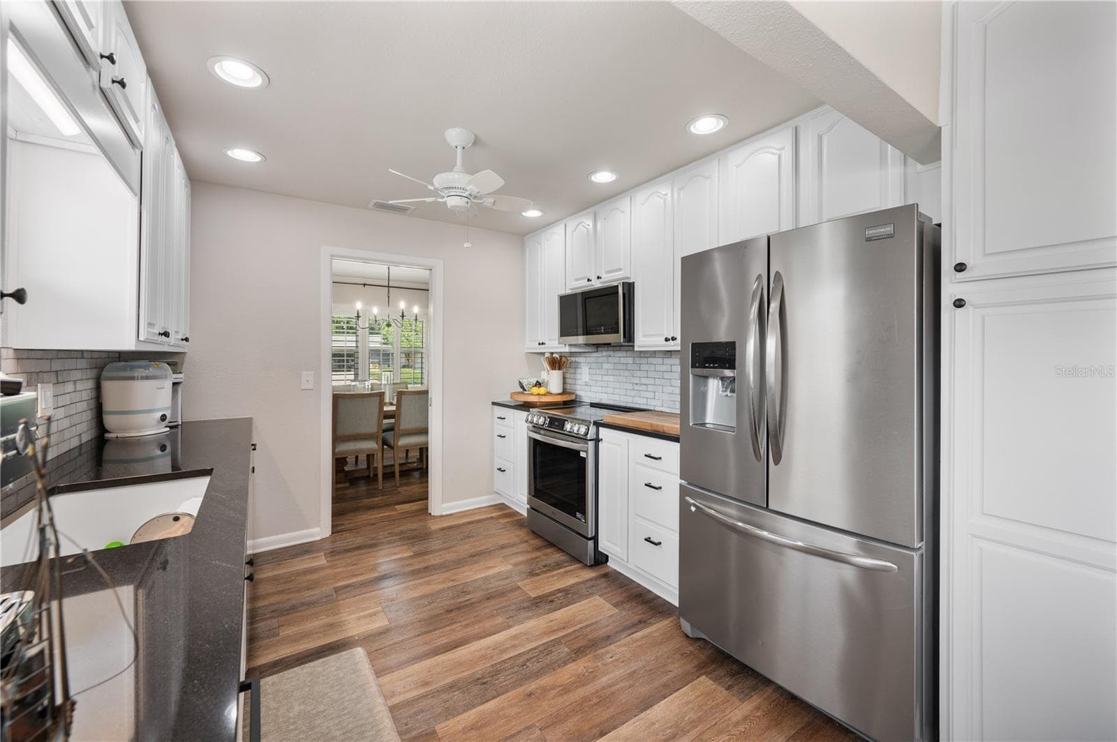 The eat-in kitchen features ..Stainless appliances, quartz counter tops , recessed lighting, plenty of storage ,newer cabinetry. - 1211 HUNT AVE, LAKELAND