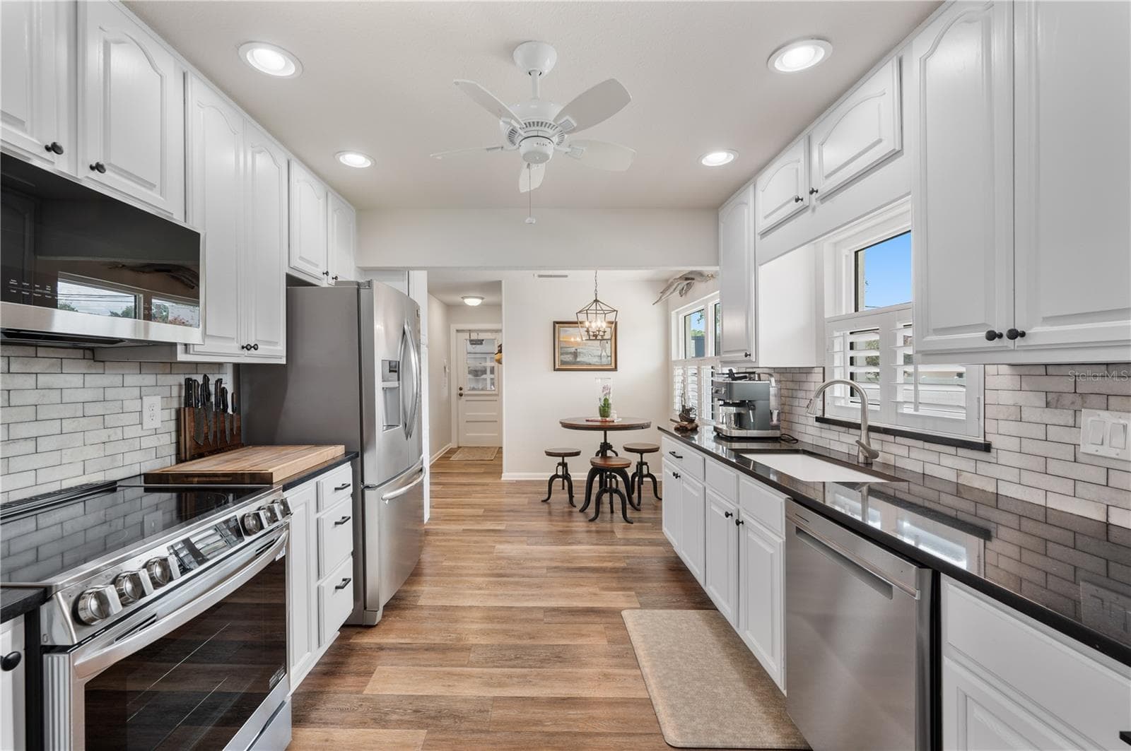 Flooded with natural light...the eat-in kitchen is charming and flows directly into the garage and the homes large half bath - 1211 HUNT AVE, LAKELAND