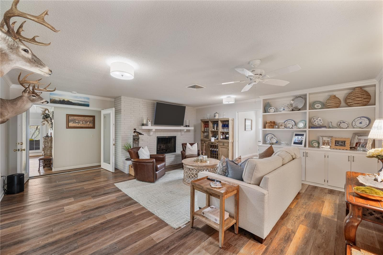 From the kitchen and foyer & into the family room, complete with a wood burning fireplace , built in storage & display along with to a HUGE game/media/TV room. - 1211 HUNT AVE, LAKELAND